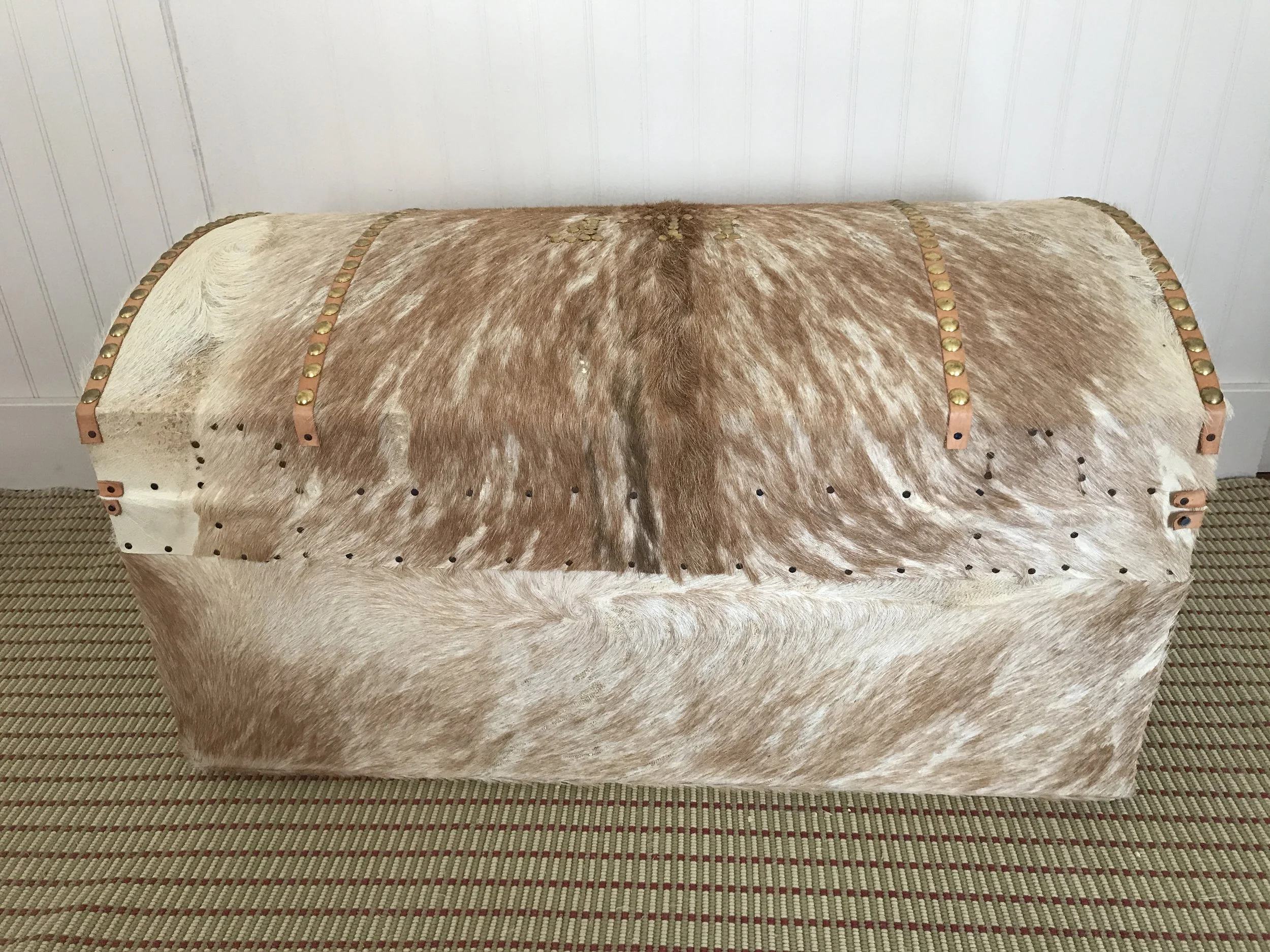 Reverse. Note the horizontal rows of tacks. The size of goats doesn't allow a single unbroken length of hide to extend from the front, over the top, and to the bottom of the rear. The tacks secure the overlap to minimize entrance of water or dirt at 