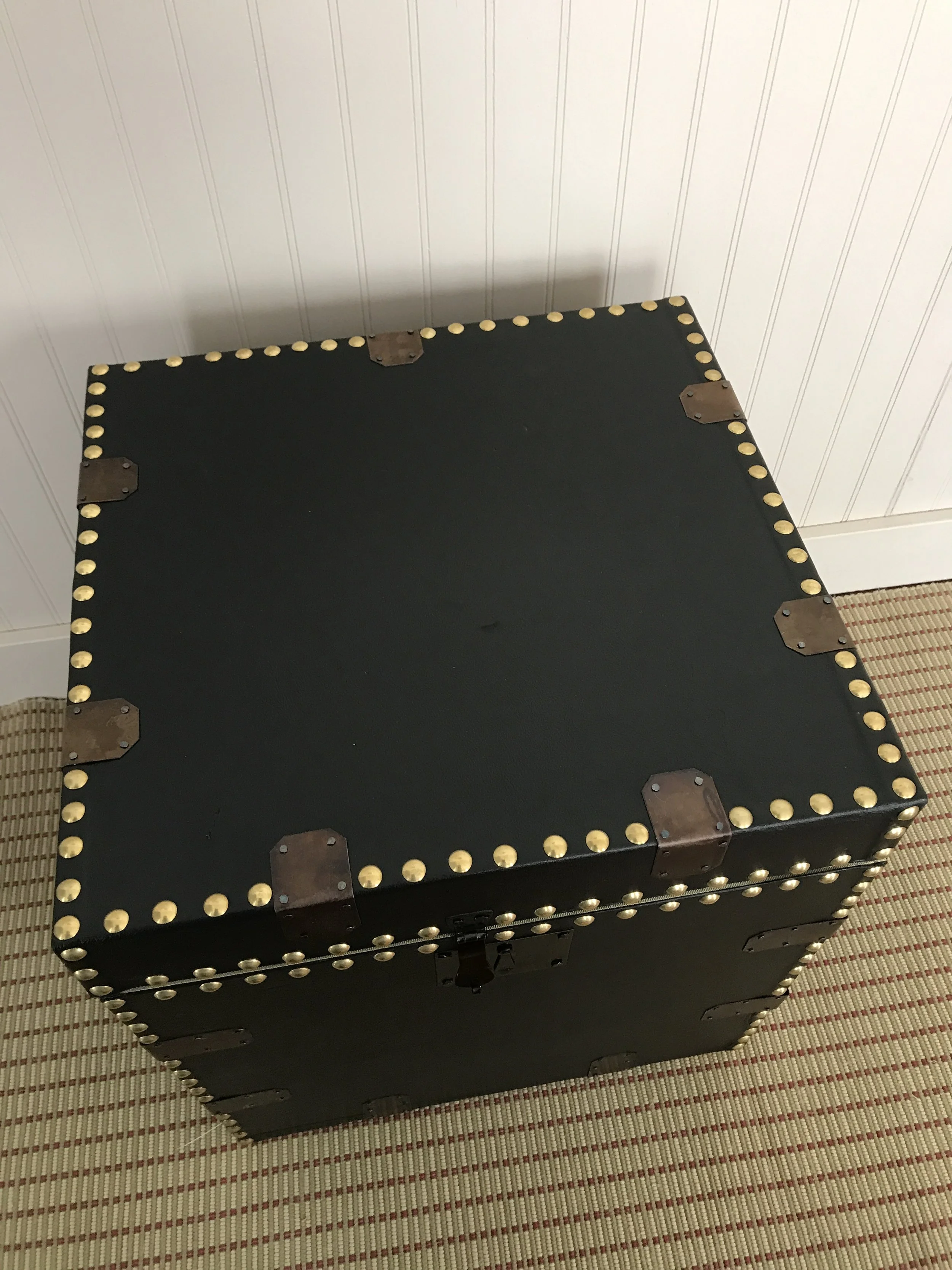 A sturdy, flat-topped trunk of suitable shape for carrying equipment or special items