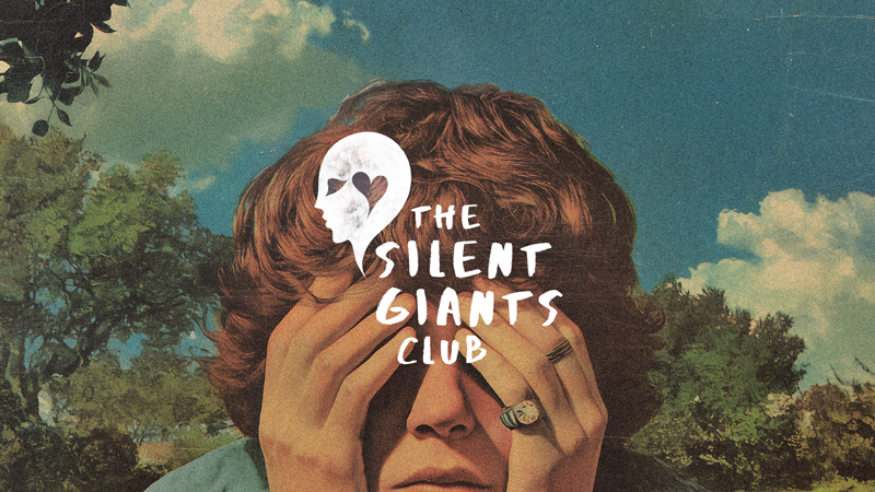 A person with curly hair covering their face with hands, with a cloudy sky and trees in the background. Overlaid text and logo read 'The Silent Giants Club'.