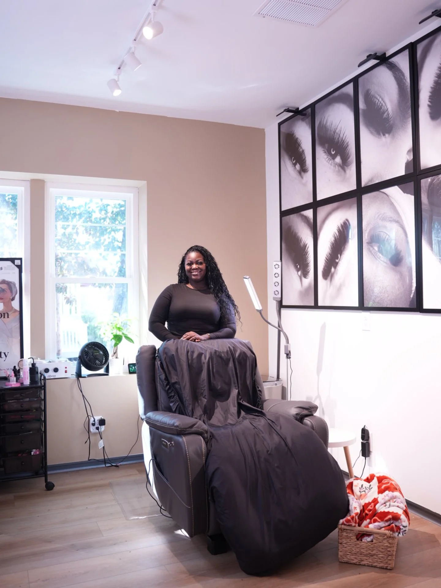 Interior of a hair salon with two mirrors, black hair styling chairs, and a neon sign on the wall that reads "You're like really pretty."