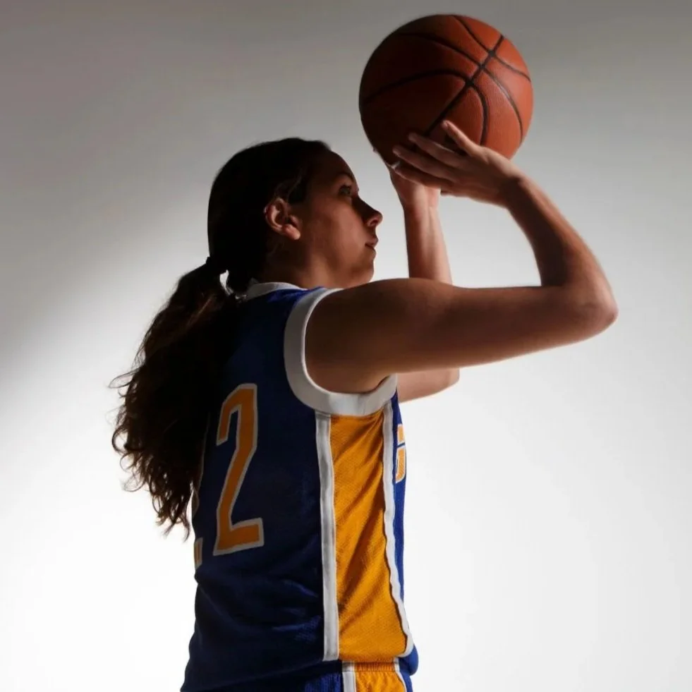 girl shooting a jump shot