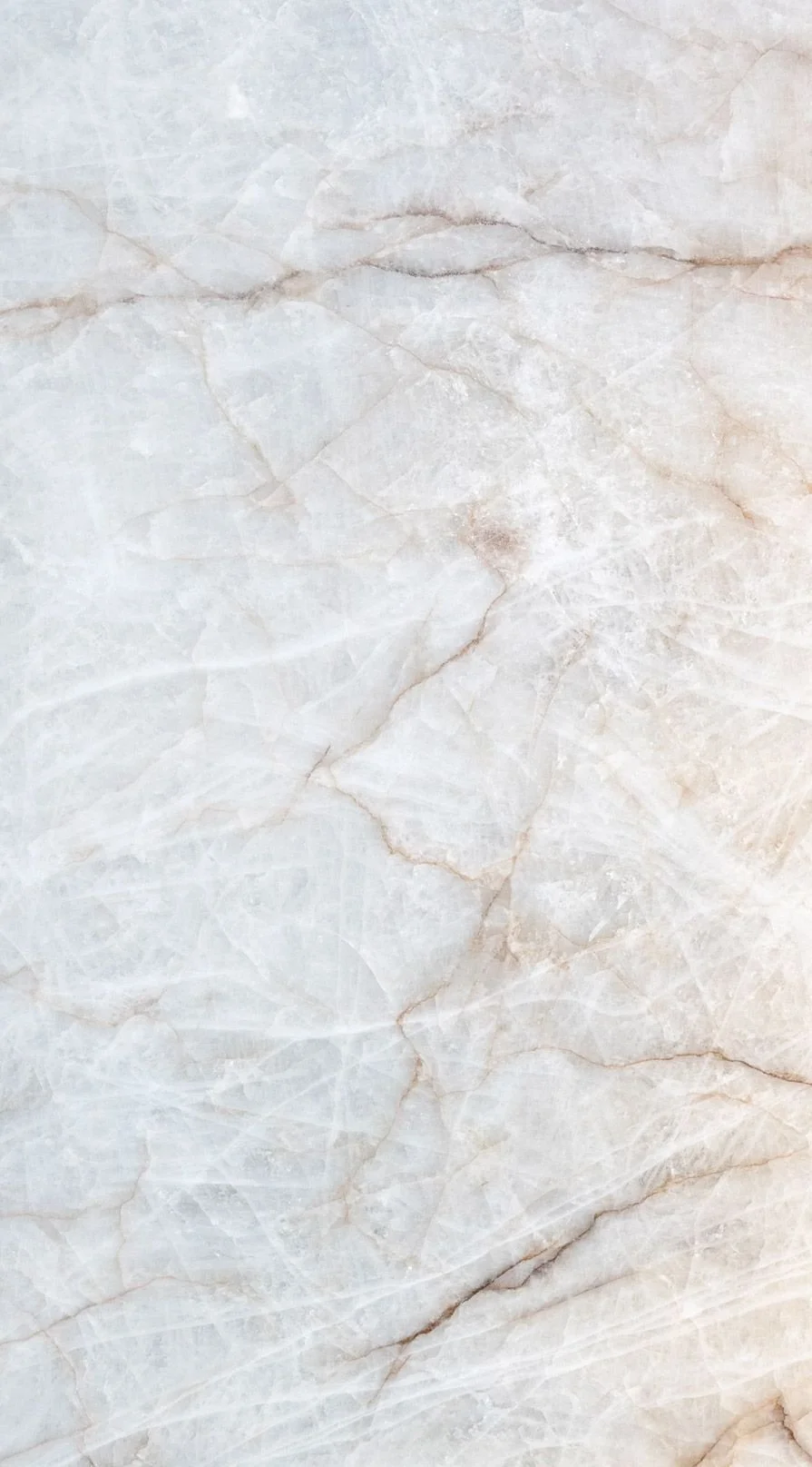 Close-up of a light-colored marble surface with natural veining