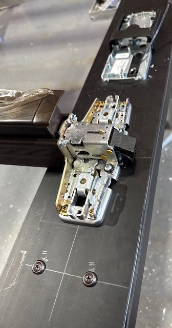 custom electric hardware being installed on a aluminum storefront door