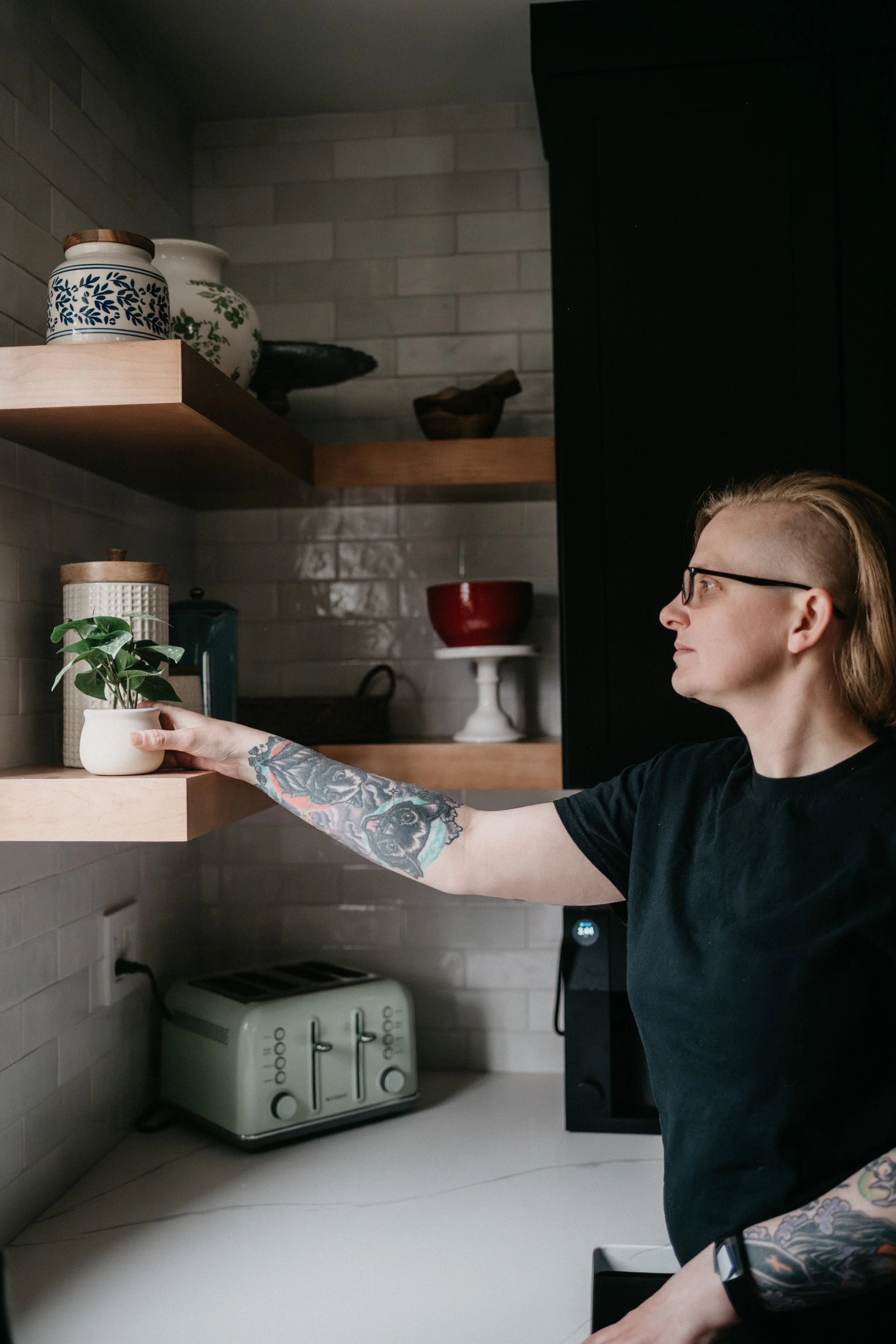 Woman placing plant on shelf