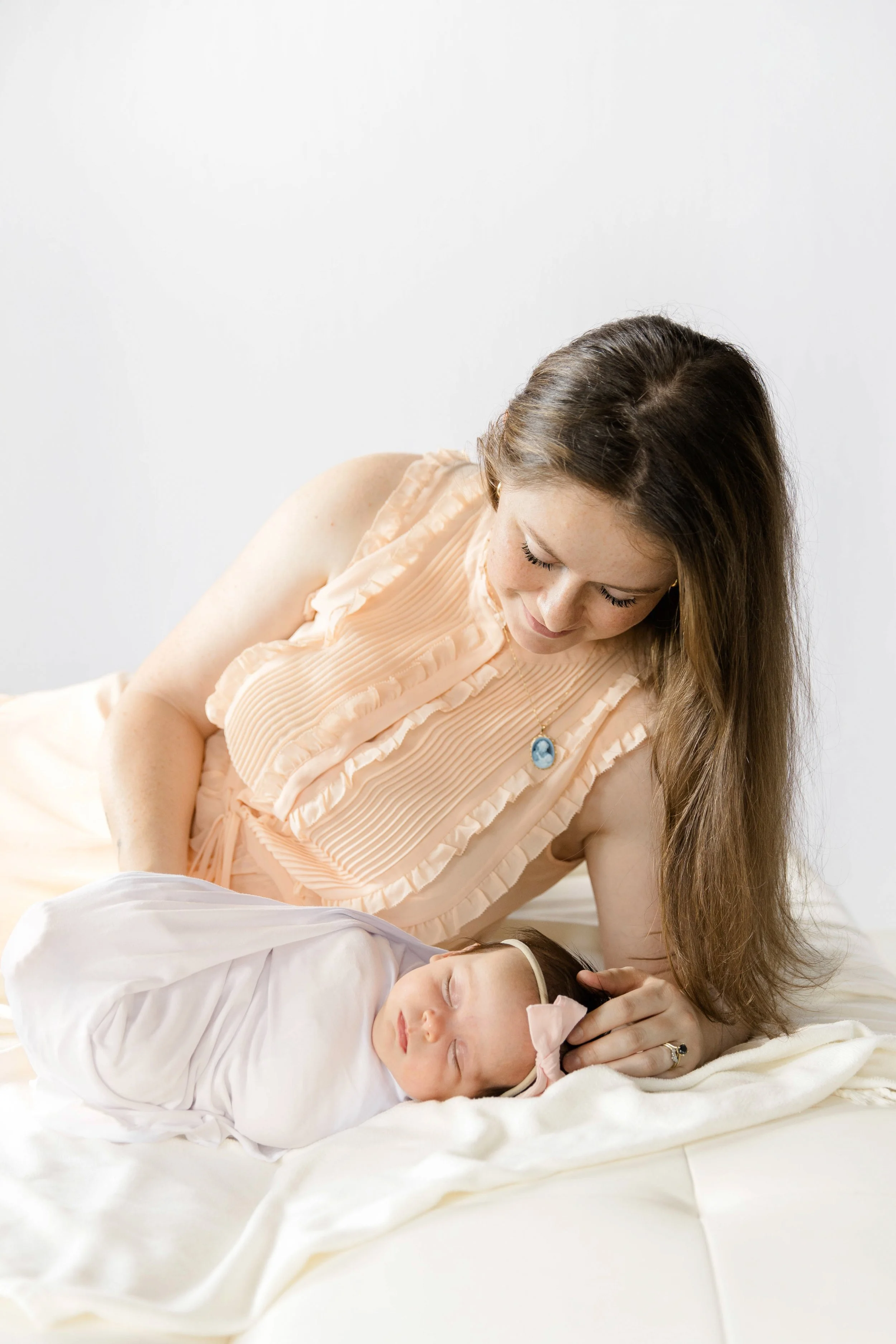 mother looking lovingly at her new baby girl