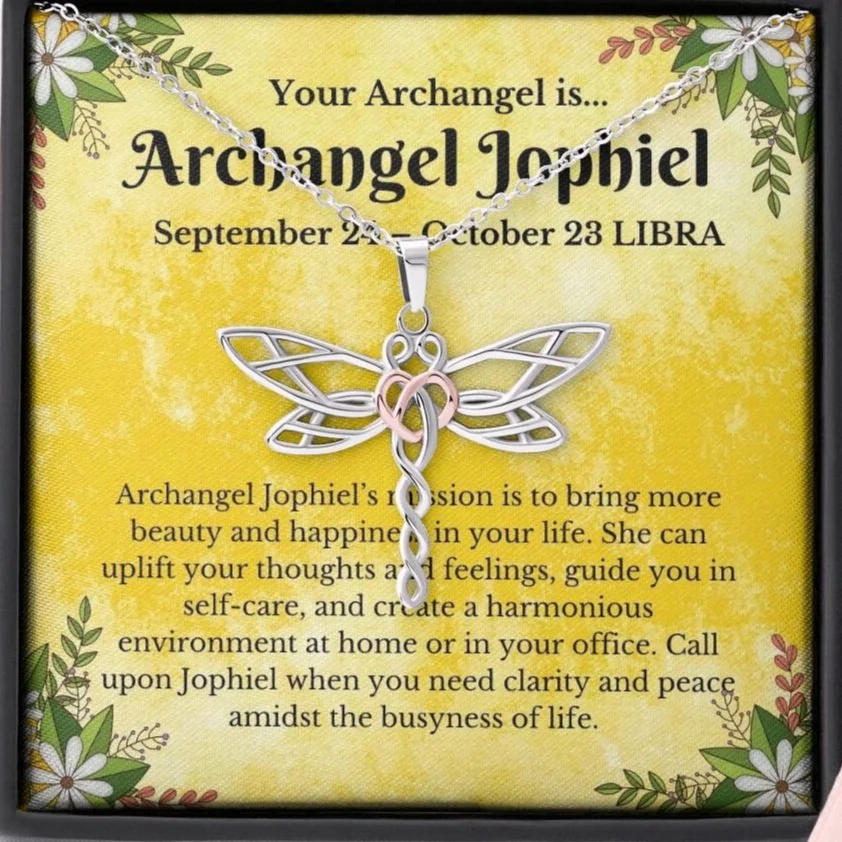 A necklace with a dragonfly pendant inside a display box, accompanied by an informational card about the Archangel Jophiel, with decorative floral borders on a yellow background.