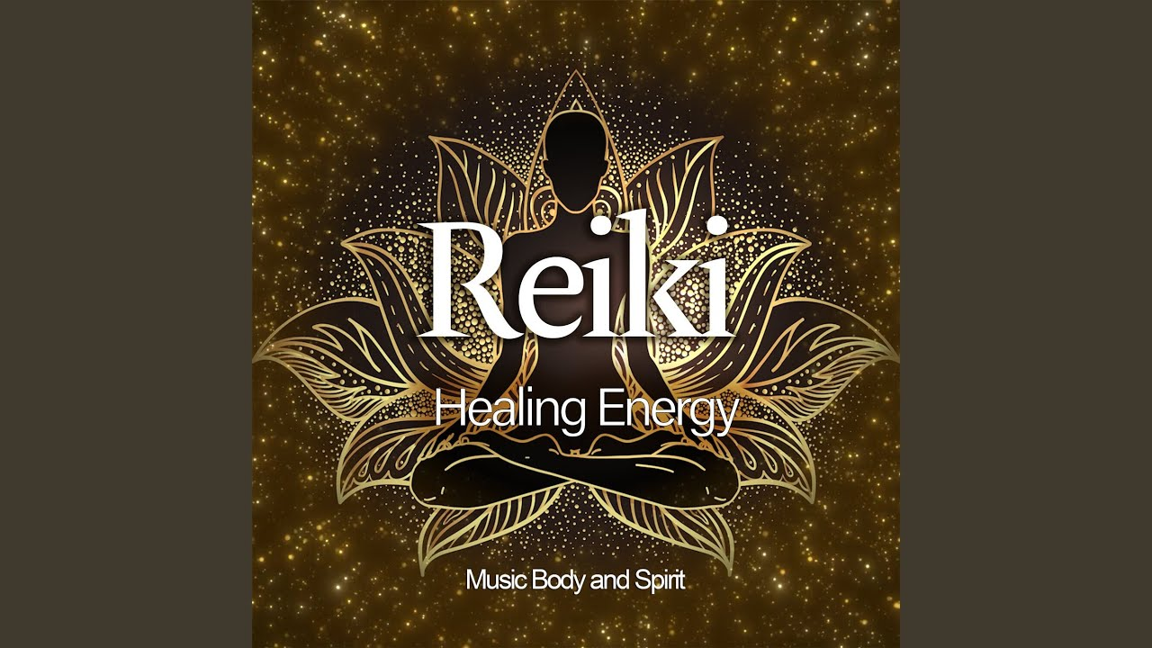 A woman sitting on a decorative rug surrounded by seven glass singing bowls in a room with wooden cabinets.