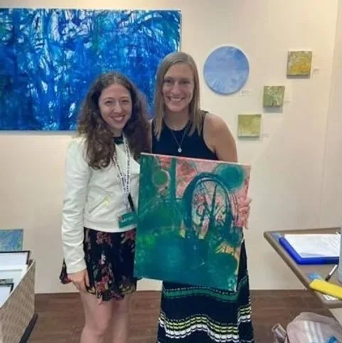 image of Nicole Javorsky with the buyer of one of her paintings at The Other Art Fair in Brooklyn, NY