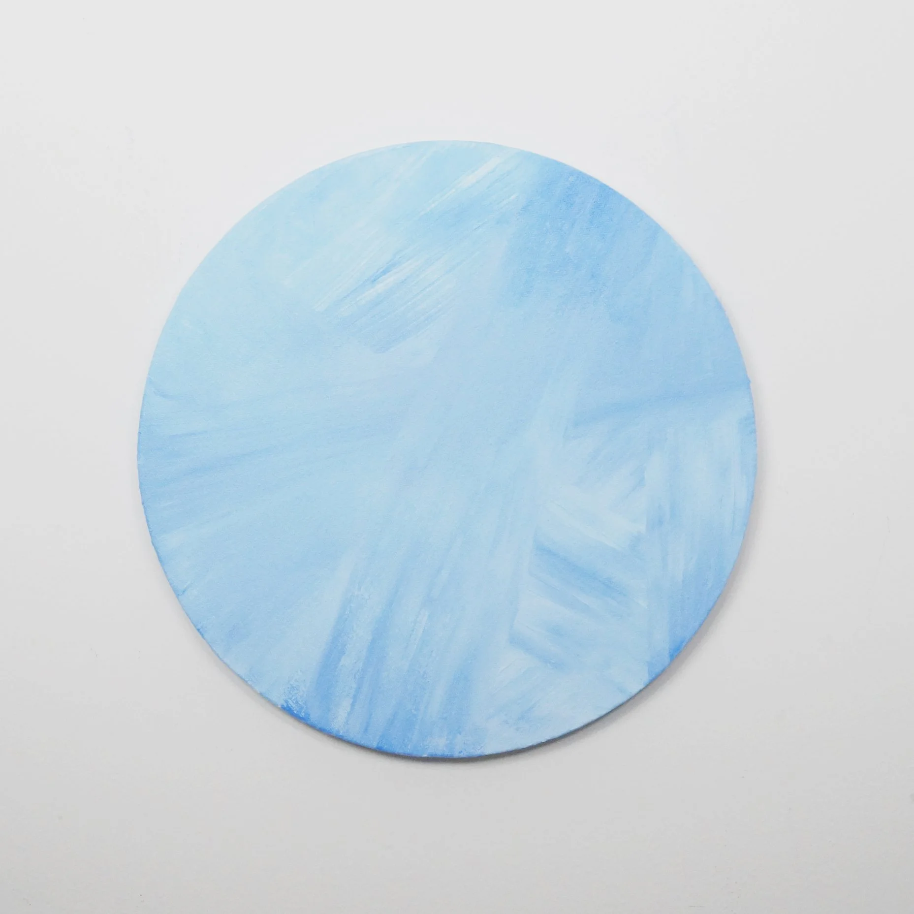 abstract blue painting on circle canvas by artist Nicole Javorsky