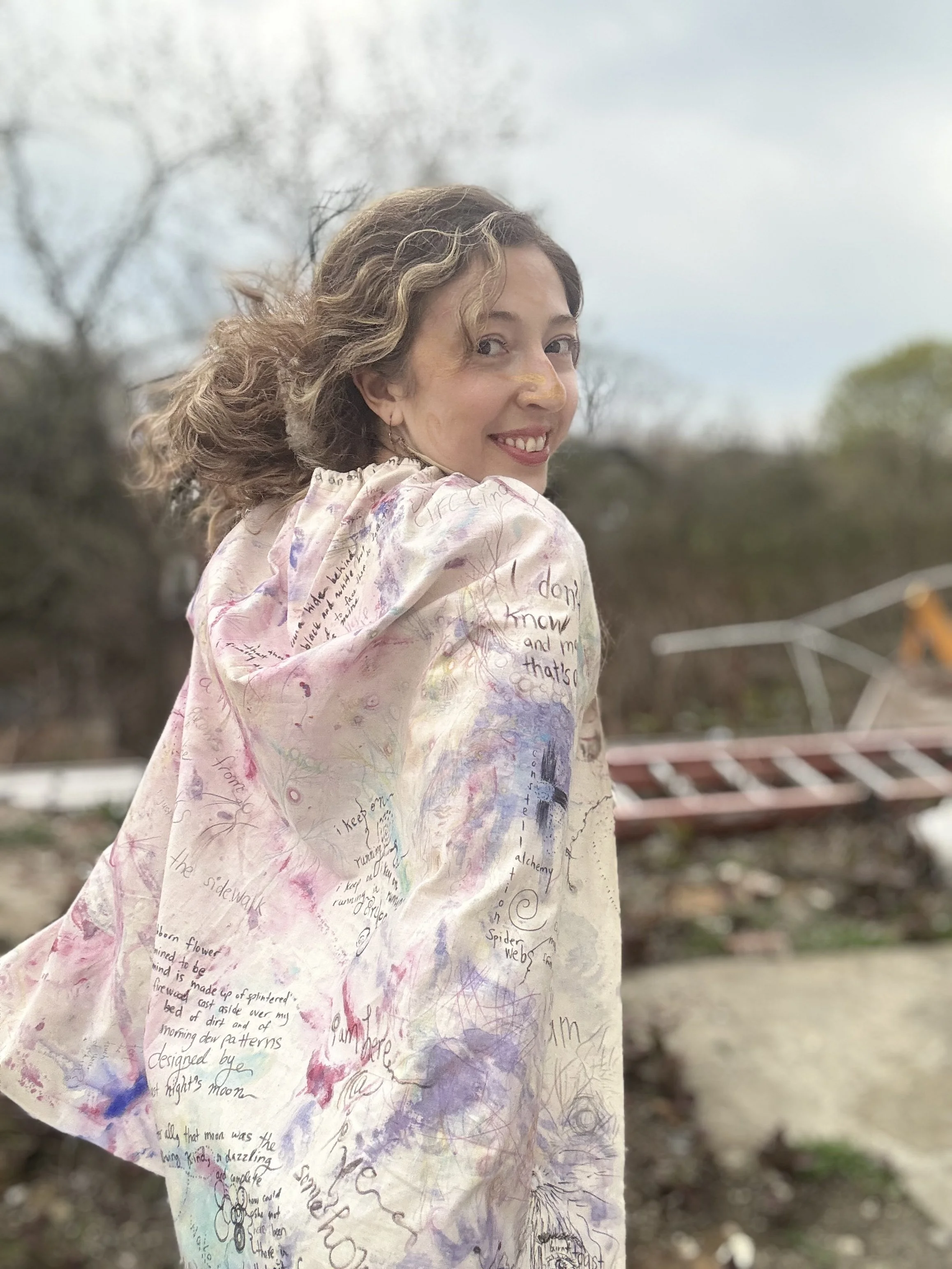 image of artist Nicole Javorsky wearing a cape she made