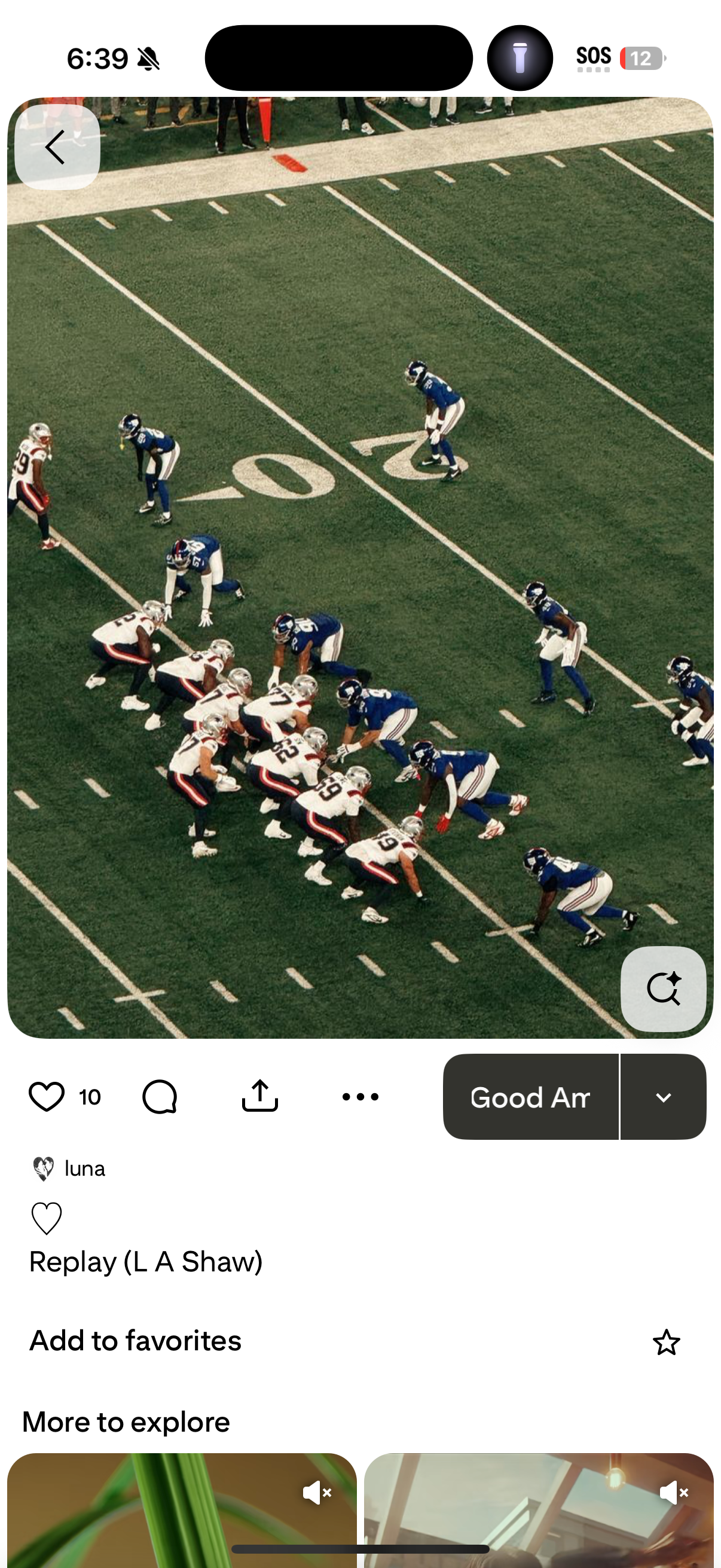 An American football game with players lined up at the line of scrimmage on a green field. The team in white jerseys and red and black pants is on offense, and the team in blue jerseys is on defense.
