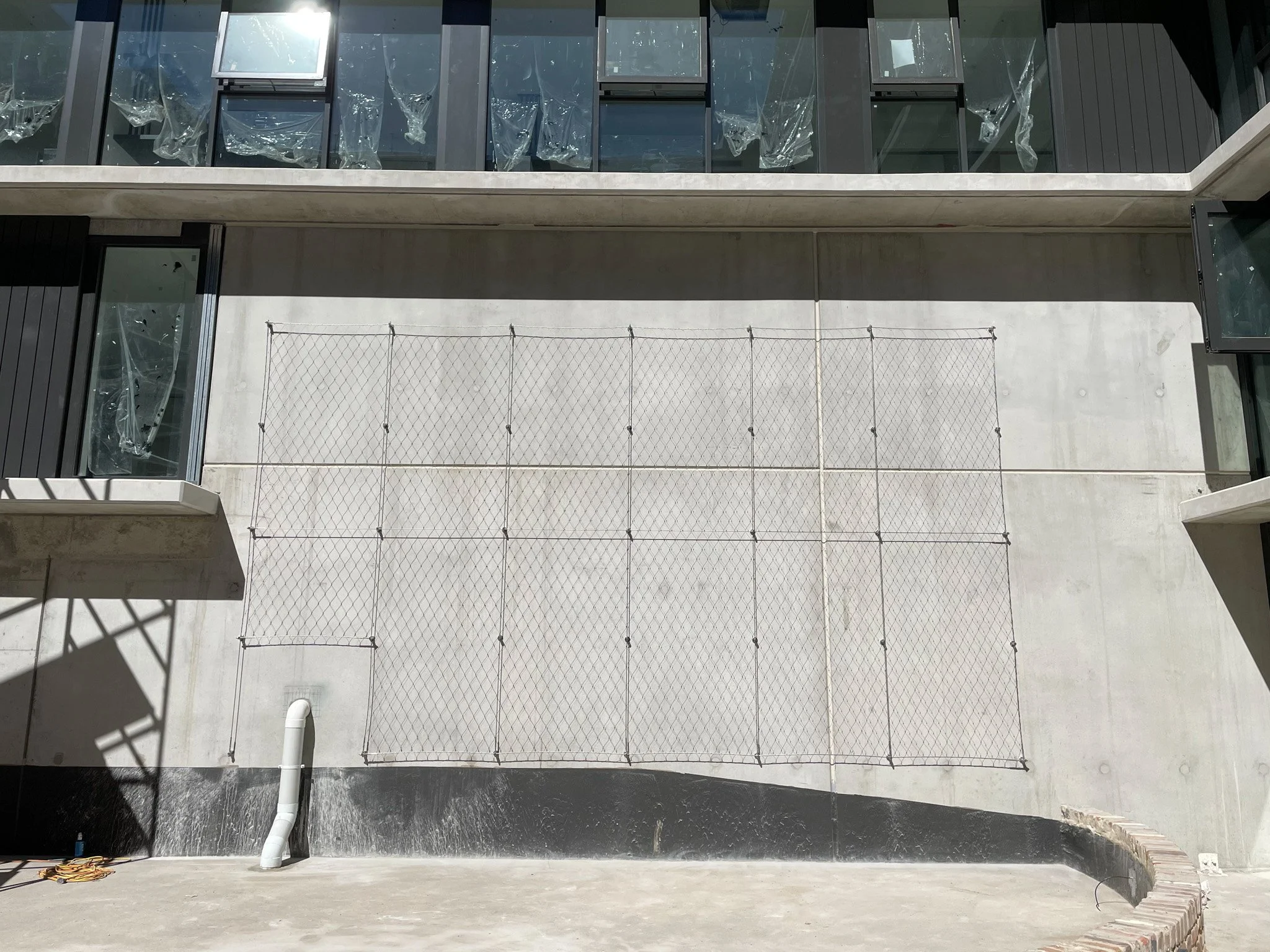 Flexi-mesh green wall system installed by Bespoke Wire & Rope in Campbell ACT with ICON and Front Architects.