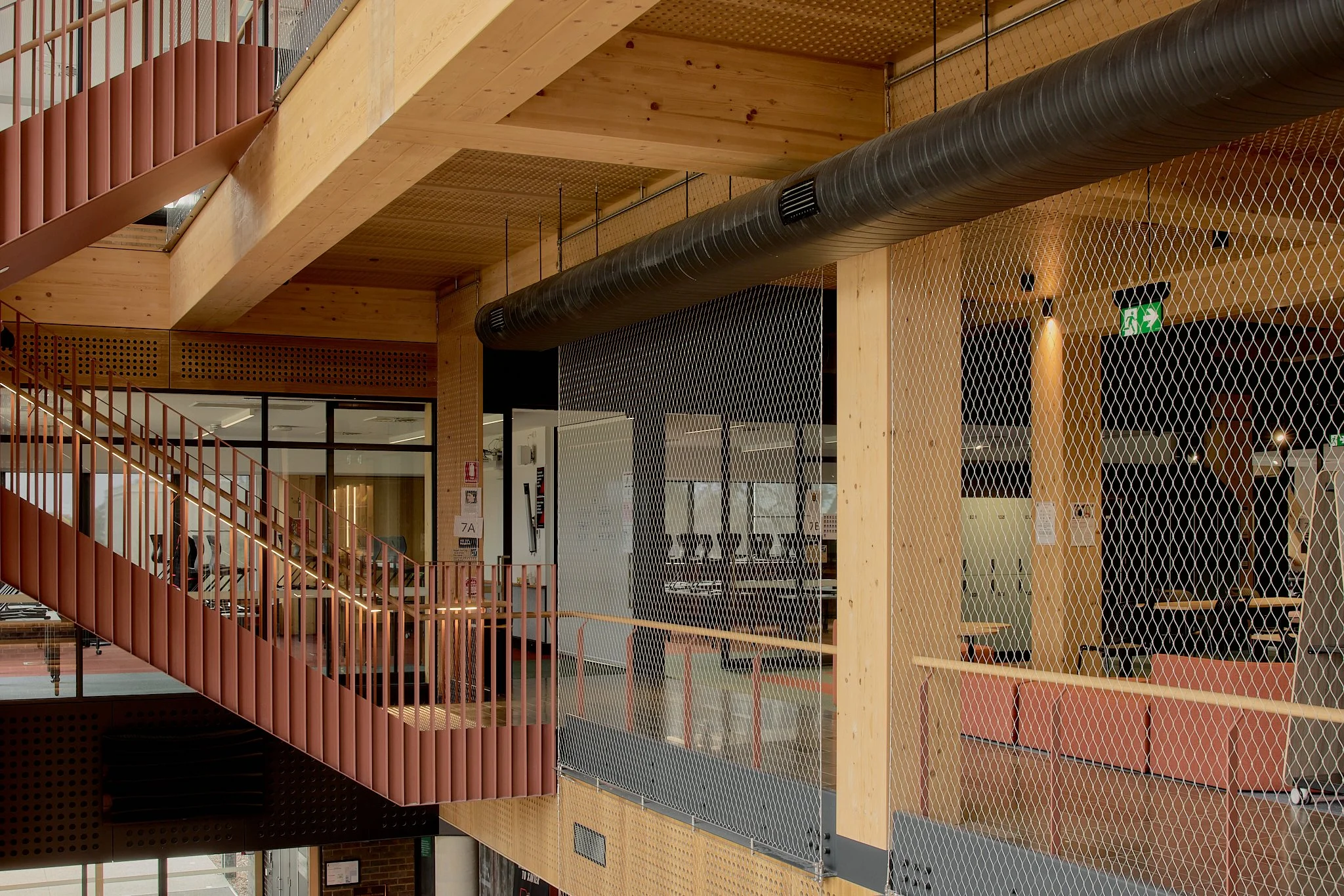 Floor-to-ceiling Flexi-mesh balustrades installed by Bespoke Wire & Rope at Xavier College Kostka Building in Kew VIC with Ireland Brown Construction, MGS Architects, and Forged Steelworks.