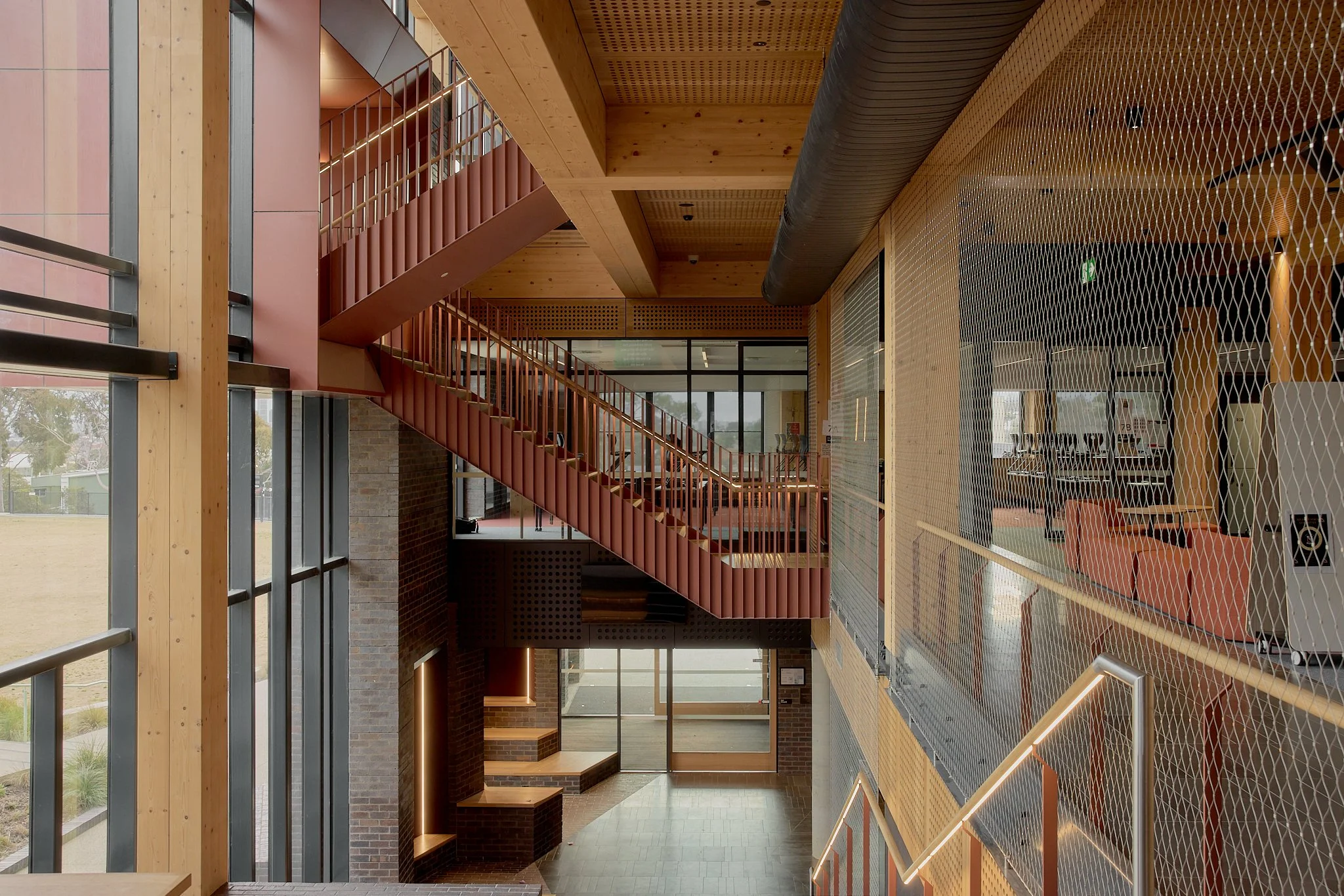 Floor-to-ceiling Flexi-mesh balustrades installed by Bespoke Wire & Rope at Xavier College Kostka Building in Kew VIC with Ireland Brown Construction, MGS Architects, and Forged Steelworks.