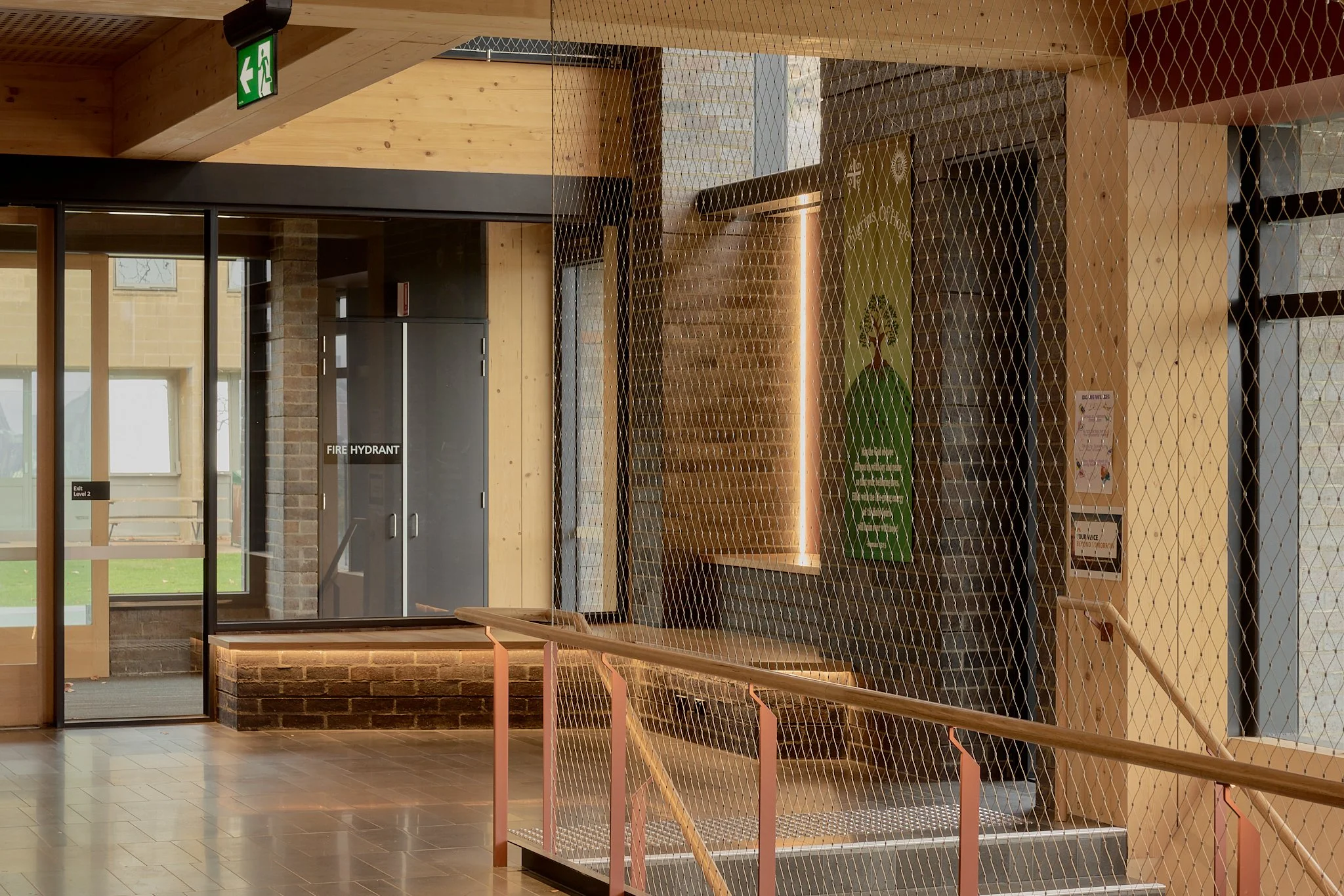 Floor-to-ceiling Flexi-mesh balustrades installed by Bespoke Wire & Rope at Xavier College Kostka Building in Kew VIC with Ireland Brown Construction, MGS Architects, and Forged Steelworks.
