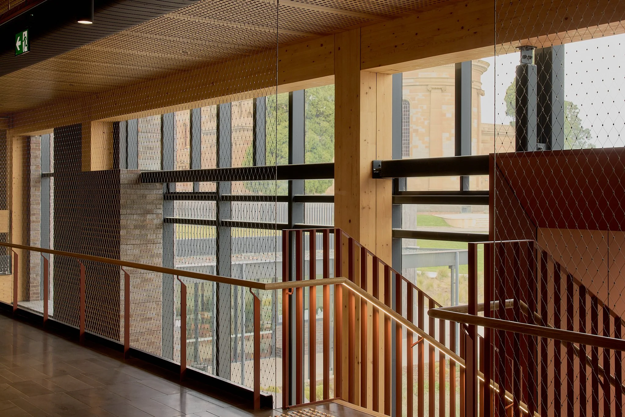 Floor-to-ceiling Flexi-mesh balustrades installed by Bespoke Wire & Rope at Xavier College Kostka Building in Kew VIC with Ireland Brown Construction, MGS Architects, and Forged Steelworks.