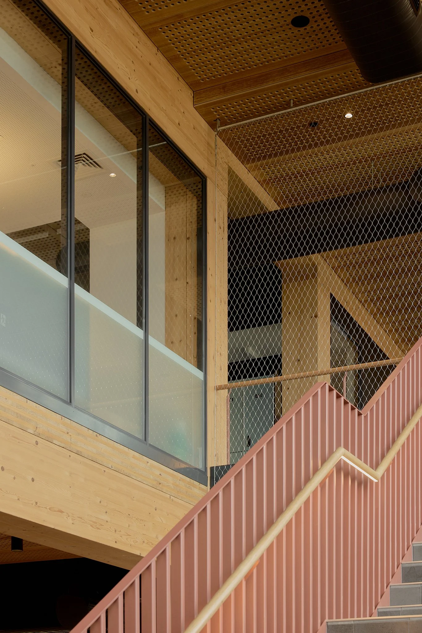 Floor-to-ceiling Flexi-mesh balustrades installed by Bespoke Wire & Rope at Xavier College Kostka Building in Kew VIC with Ireland Brown Construction, MGS Architects, and Forged Steelworks.