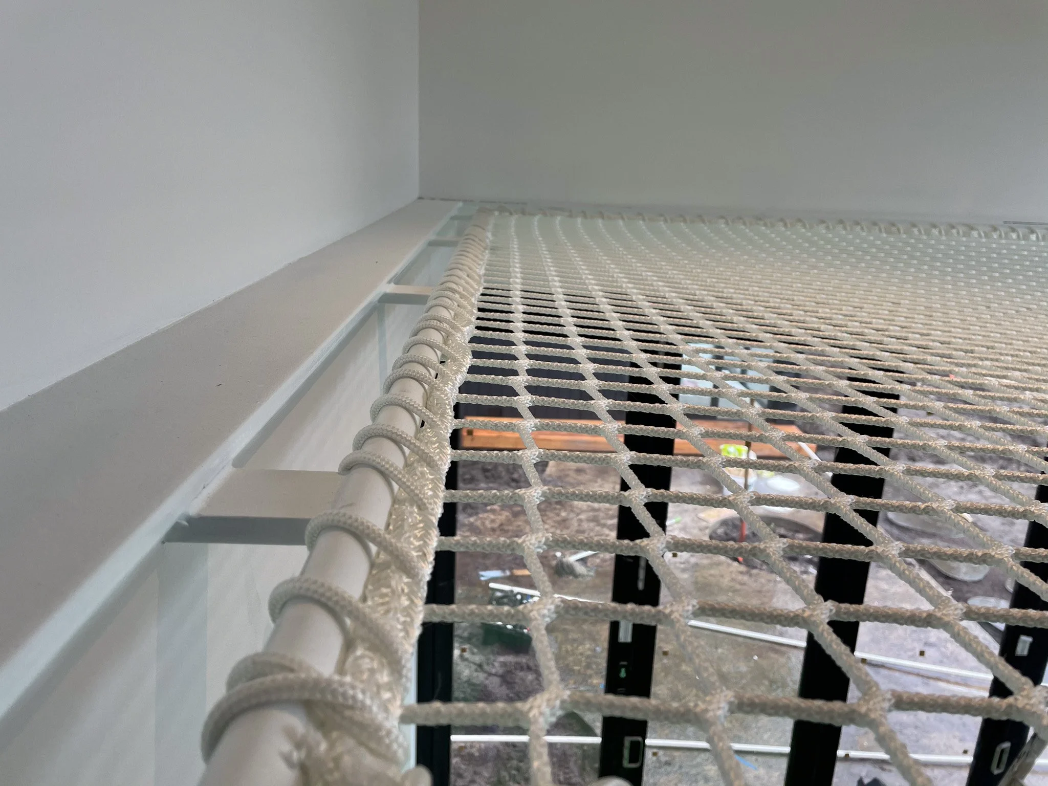 Residential hammock net in Hampton VIC designed and installed by Bespoke Wire & Rope with Teknik Construction. Walk-on net supported by custom steelwork, providing safety and a seamless finish.