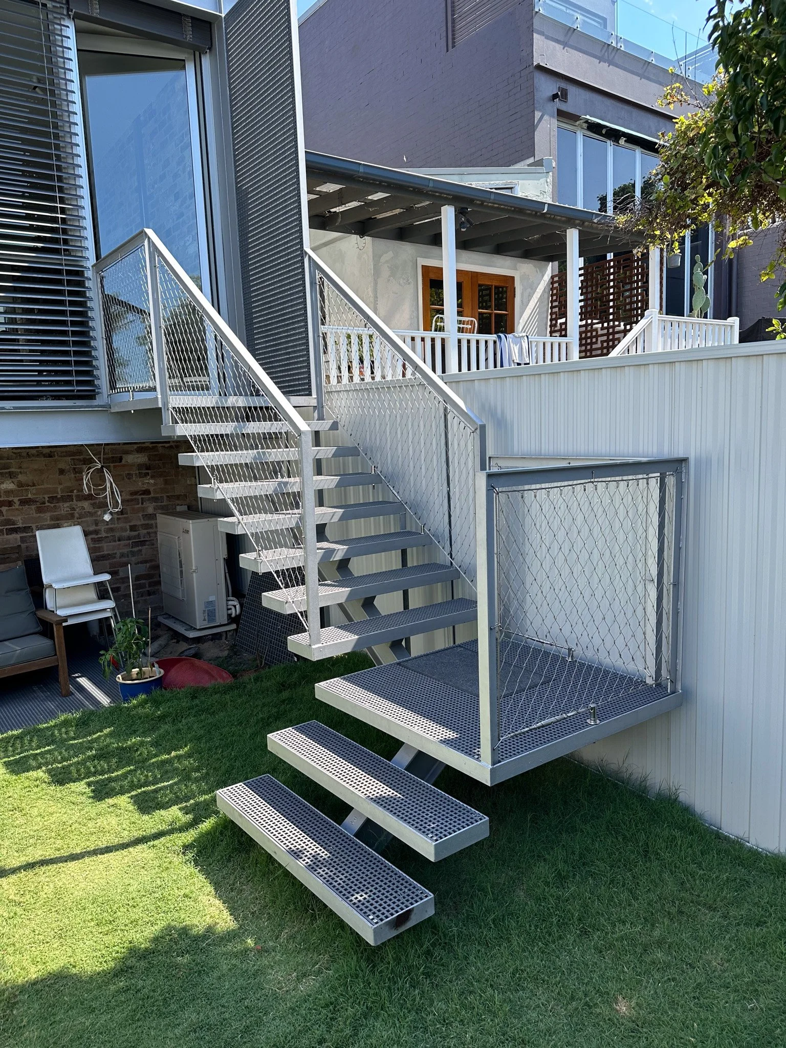 Flexi-mesh balustrades installed by Bespoke Wire & Rope in Stanmore NSW with realBUILDING, including balcony and staircase infills.
