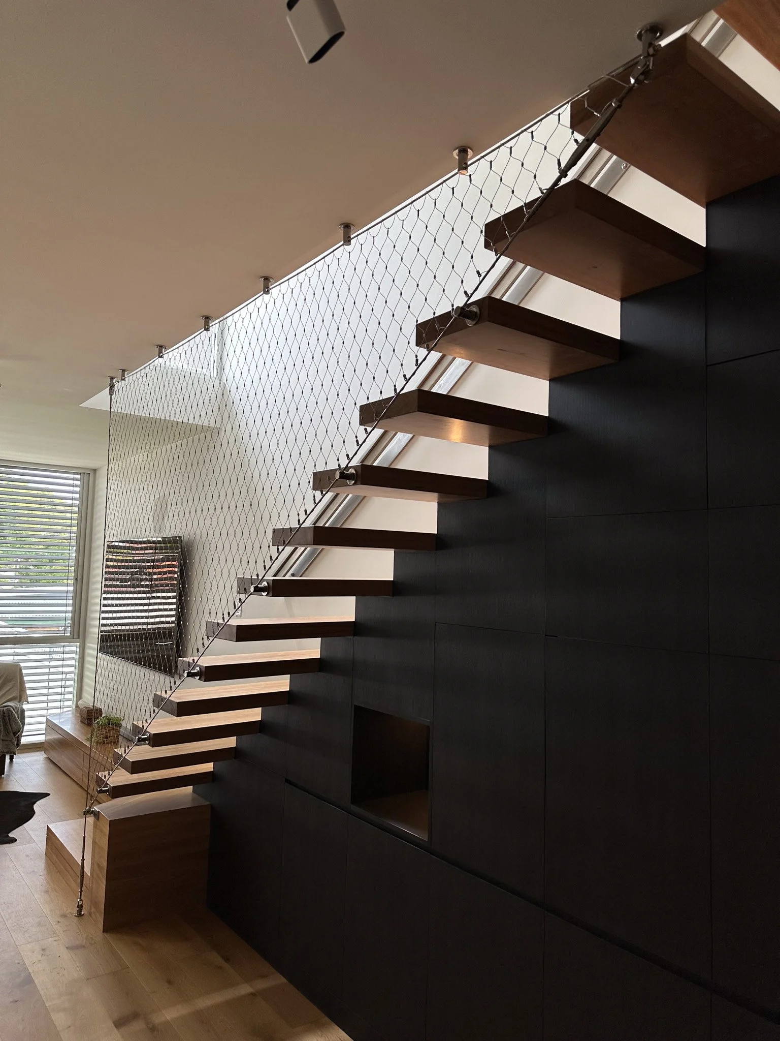 Flexi-mesh balustrades installed by Bespoke Wire & Rope in Stanmore NSW with realBUILDING, including balcony and staircase infills.