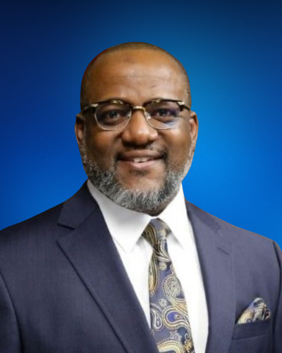 Image of Randall Evans in a navy blue suit and tie with swirly designs.
