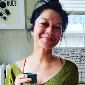 Trinity Capili smiling at home, holding a cup of tea