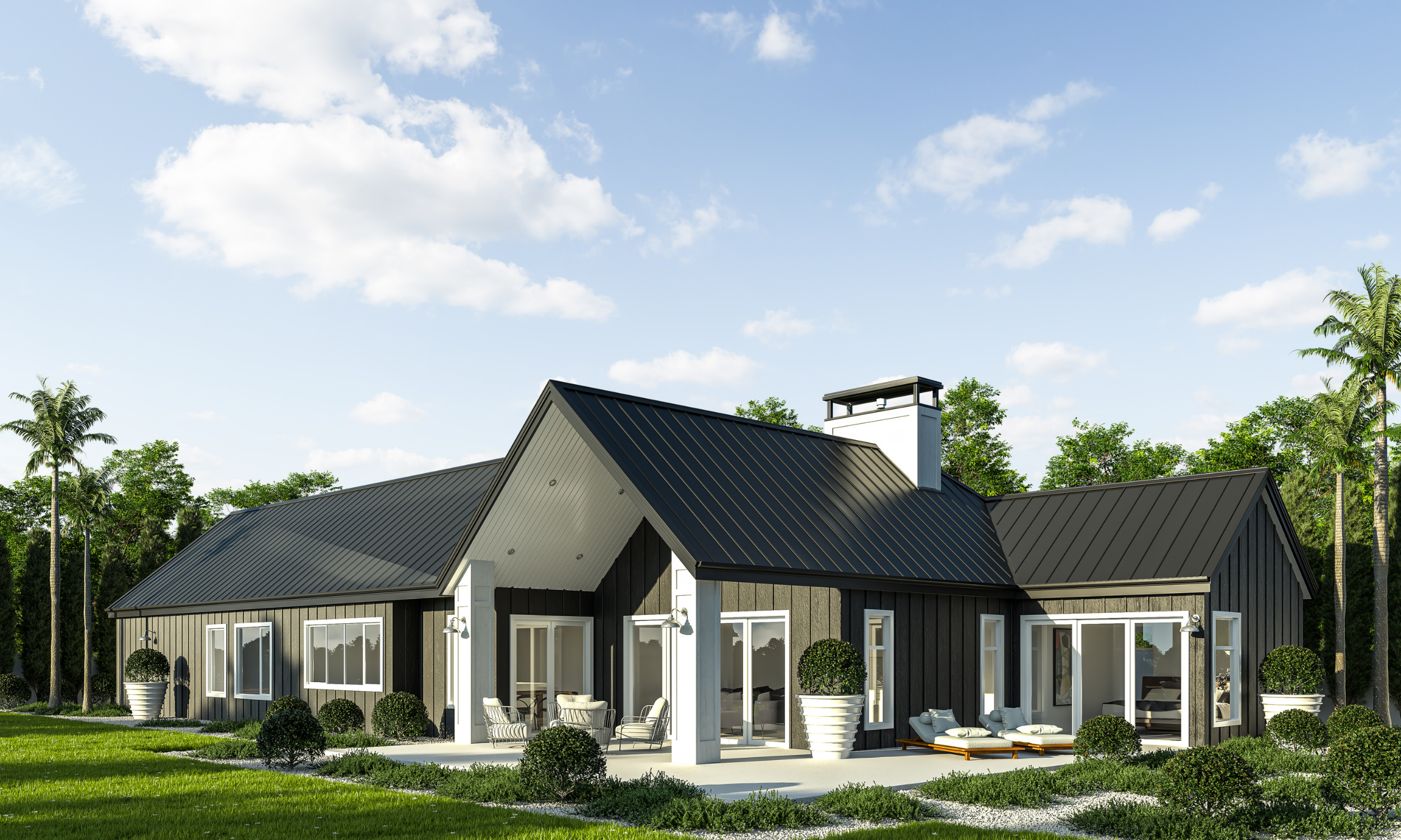 Modern black house with large windows and outdoor seating, surrounded by lush green trees and grass, under a partly cloudy sky.