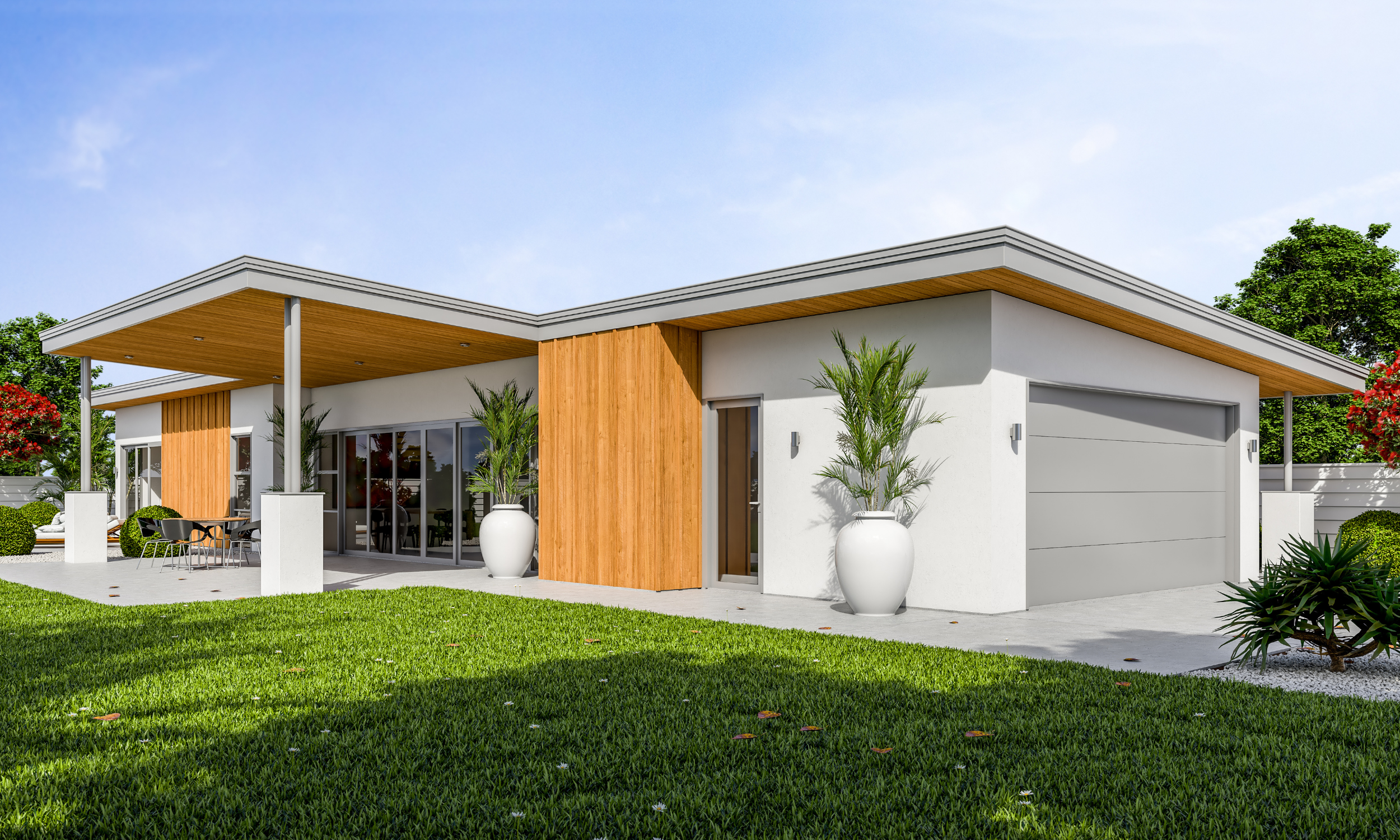 Modern single-story house with white walls, wooden accents, large glass sliding doors, and a gray garage door, surrounded by green grass and potted plants, under a blue sky.