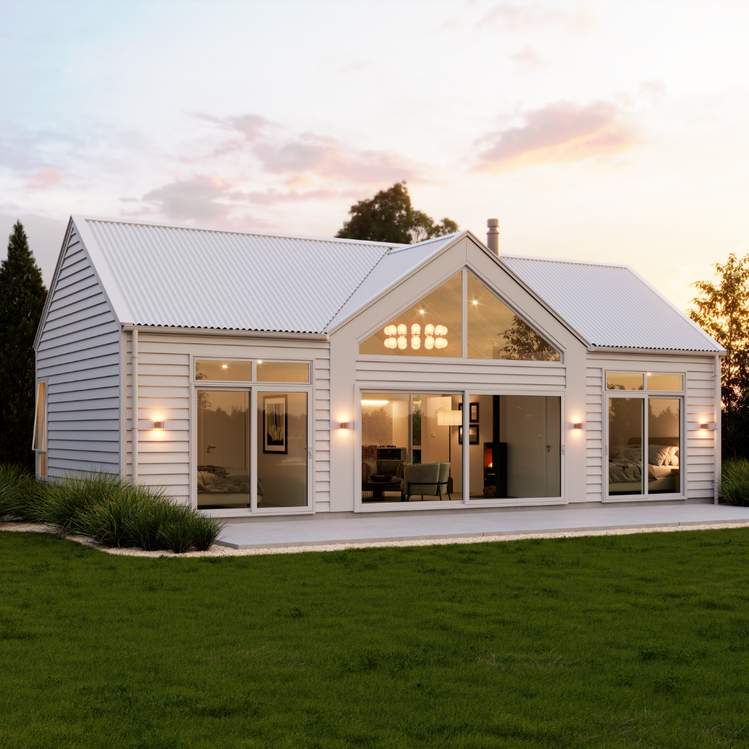 Modern white house with large glass windows and a metal roof, surrounded by green lawn and trees at sunset.