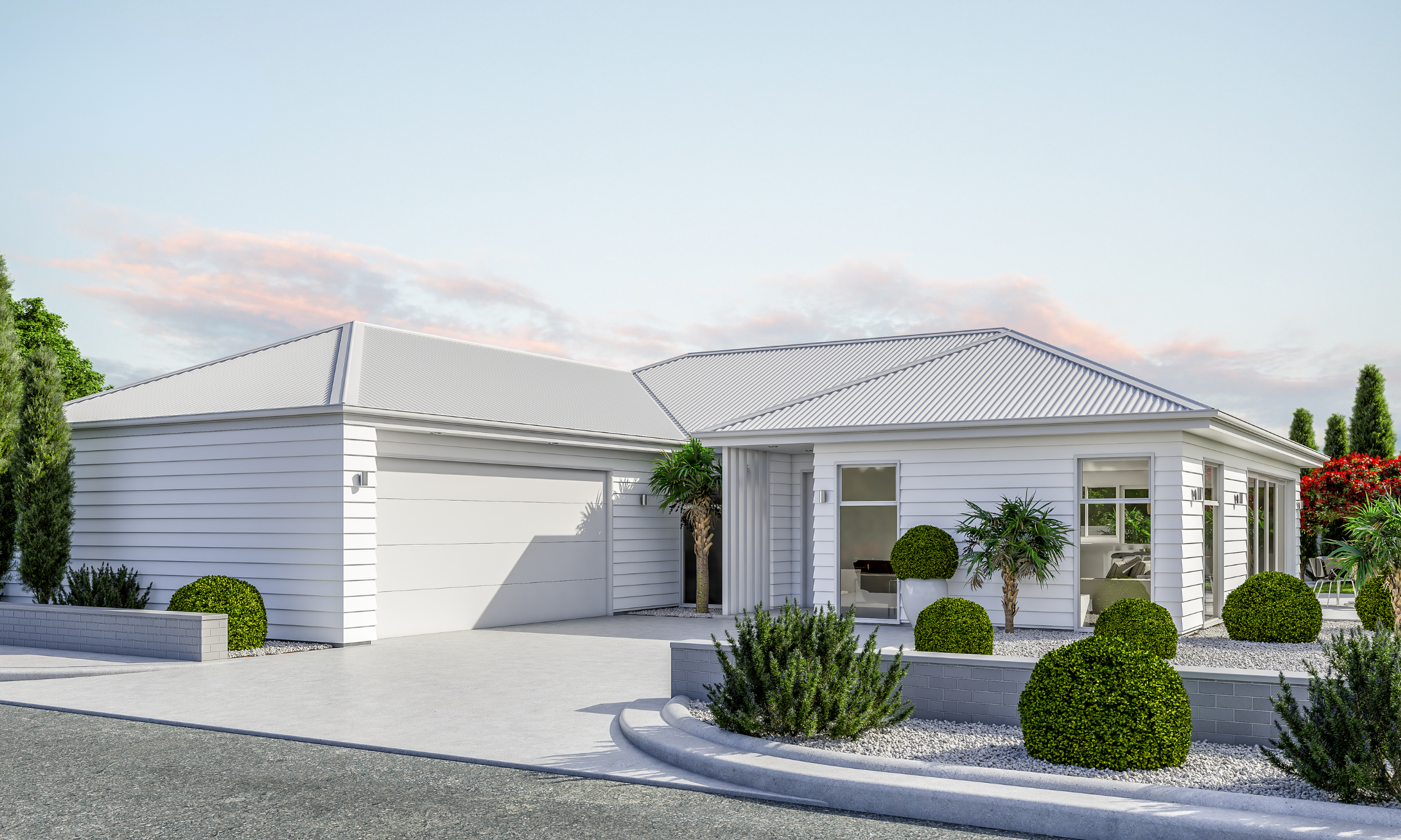 Modern white house with a metal roof, surrounded by neatly trimmed bushes and small trees, with a paved driveway and landscaped garden.