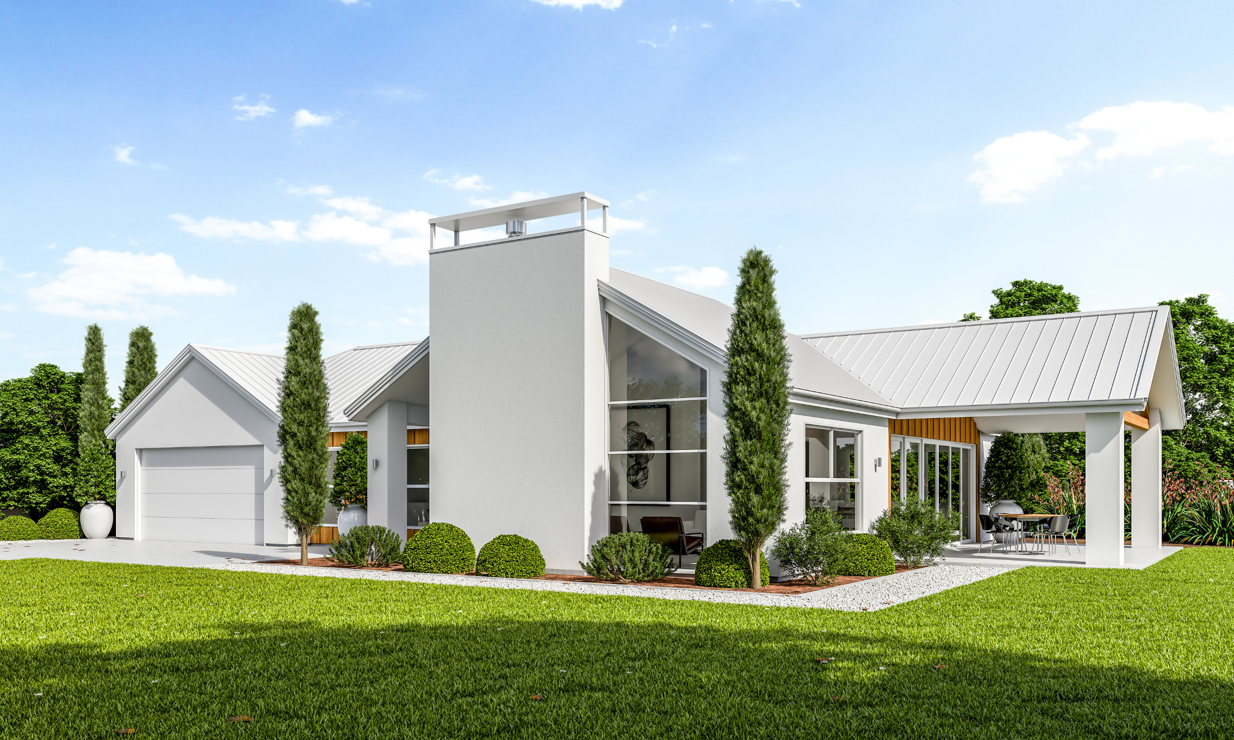 Modern white house with a metal roof, tall trees, and a well-manicured lawn. Features large windows and an outdoor patio area with seating.