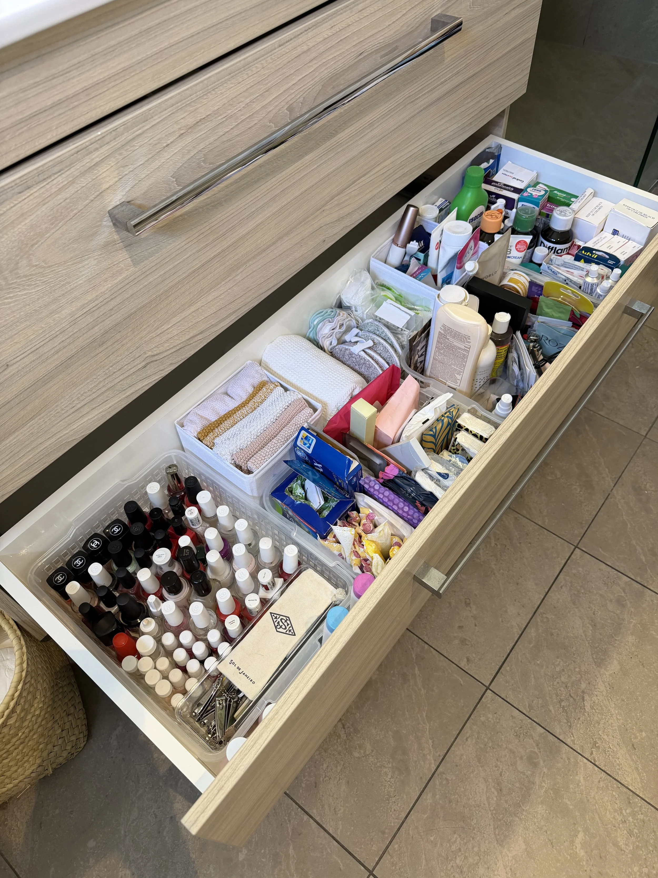 After bathroom drawer transformation by Spaces by Kat, featuring neatly arranged beauty products, skincare and toiletries organised into practical storage compartments.