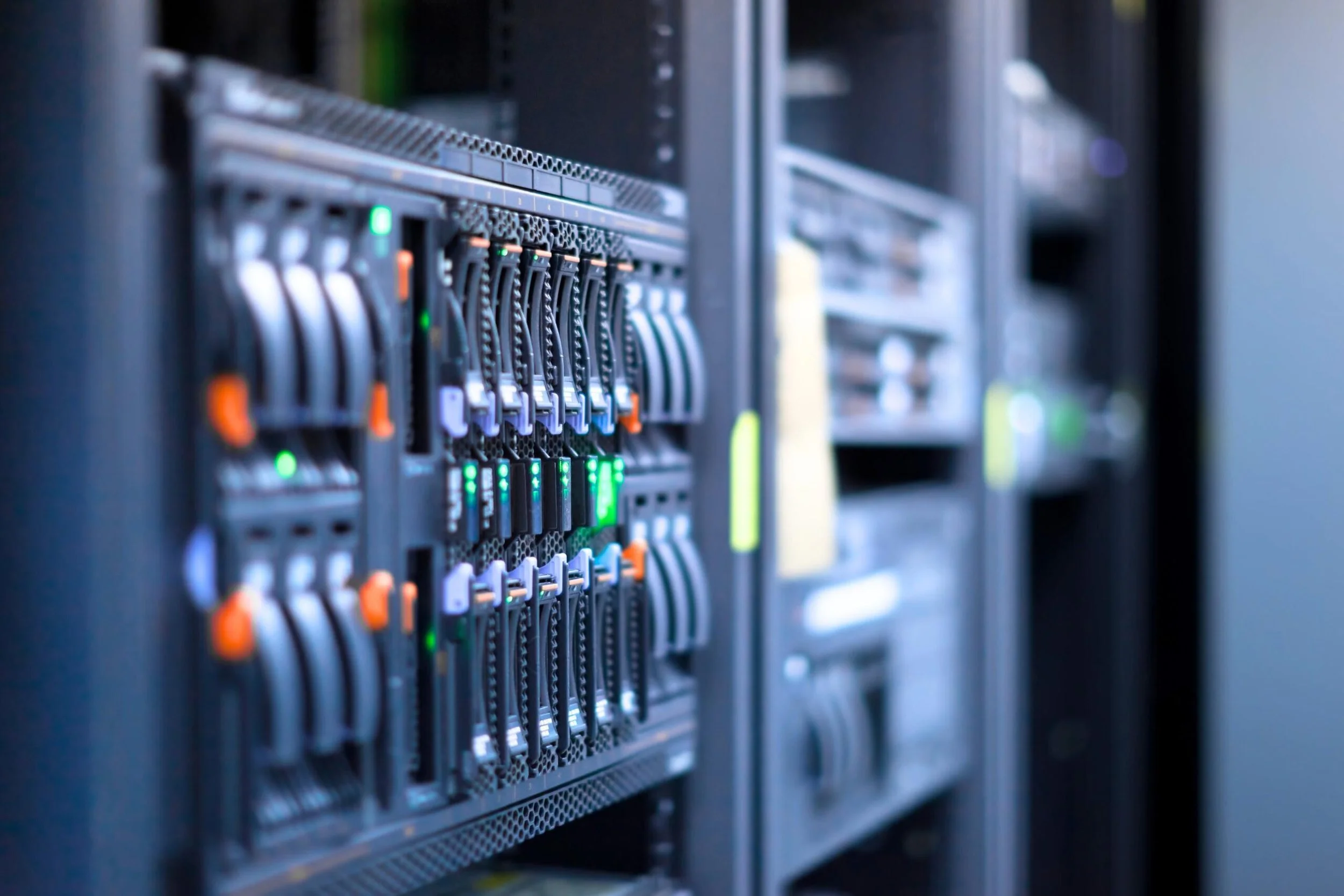 A row of server racks with blinking green and orange lights in a data center.