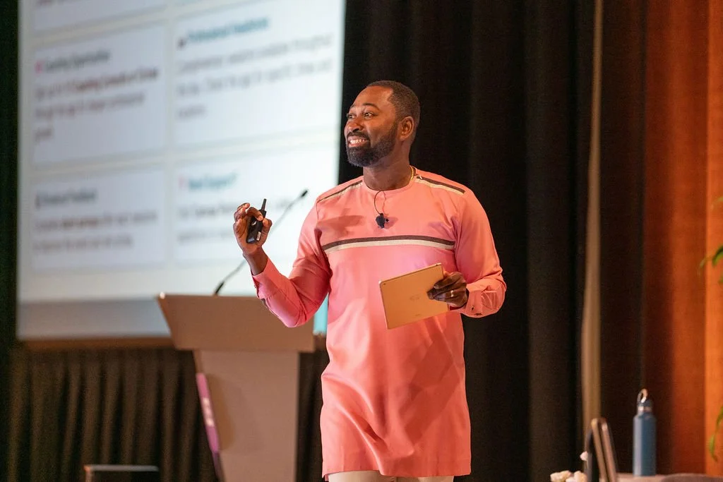 Emmanuel Manu facilitating a learning session from the stage.