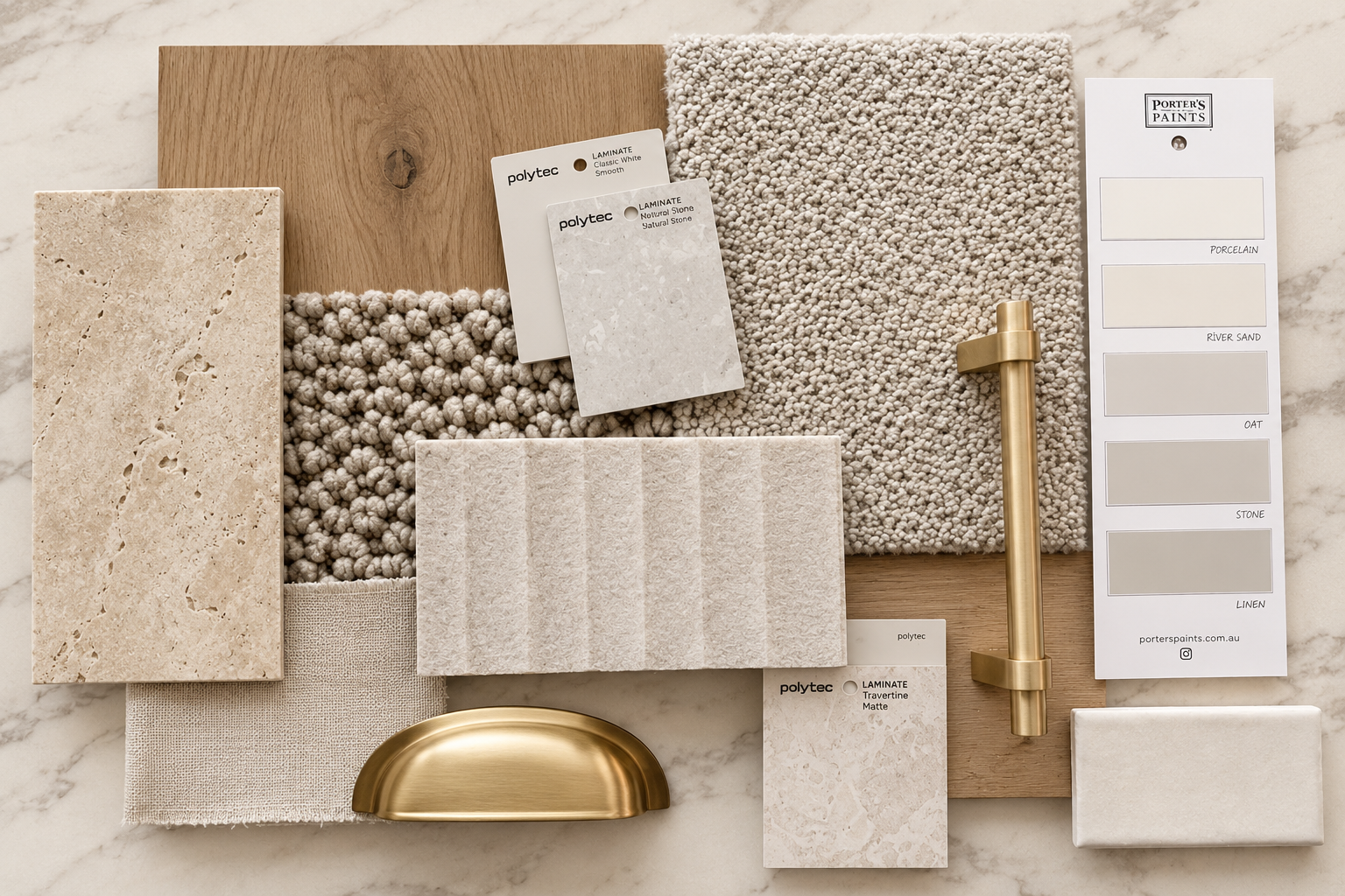 A collection of materials and samples for interior design, including different tile samples, fabric swatches, a small brass fixture, a wooden board, a paint sample chart, and various textures and colors for countertops and walls, arranged on a marble surface.