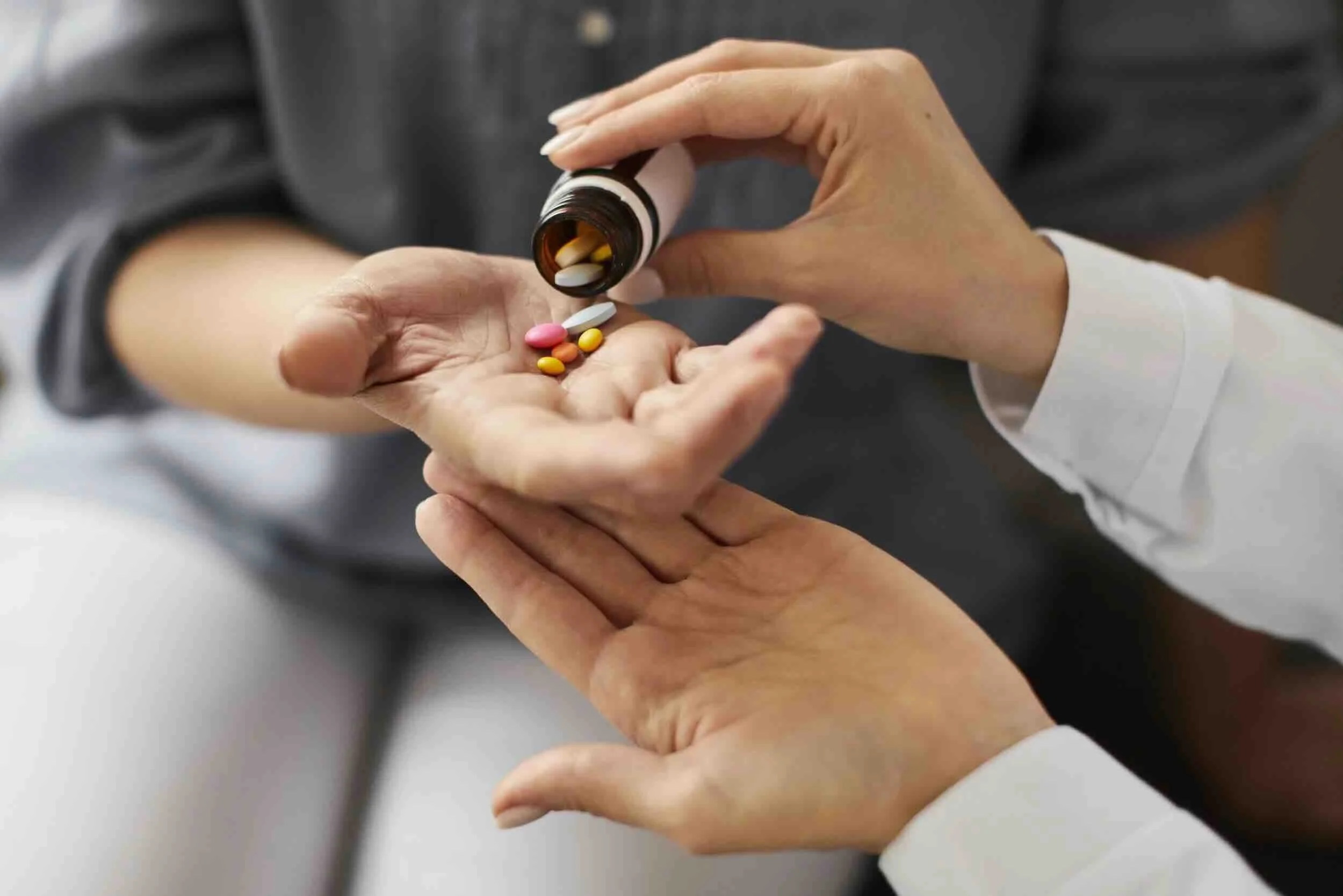 An image representing medication management, showing a person taking their prescribed pills.
