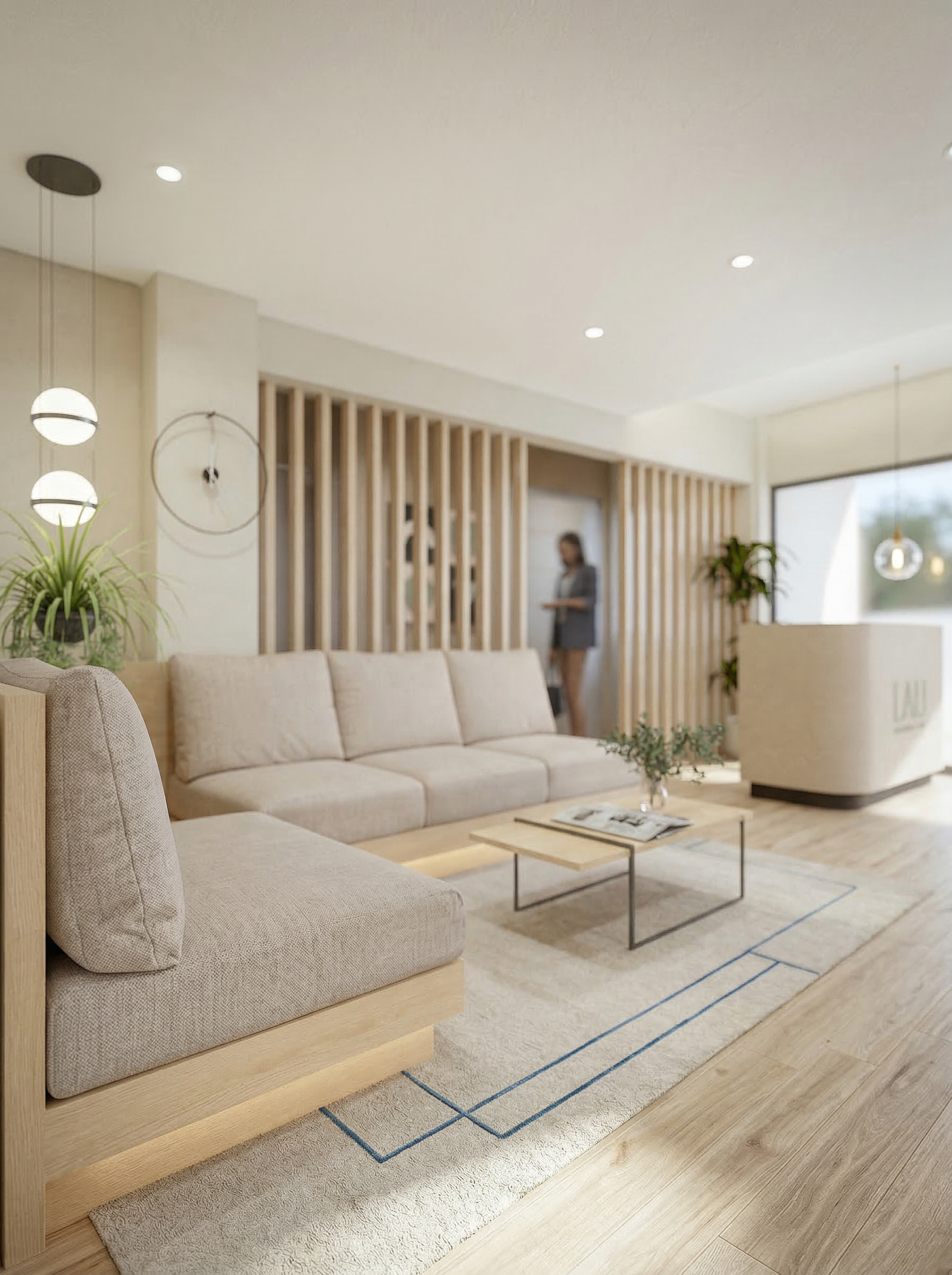 Modern, minimalistic living room with beige sofas, a glass coffee table, and light wood flooring. Potted plants and pendant lights add decor, and a woman is standing near a doorway in the background.