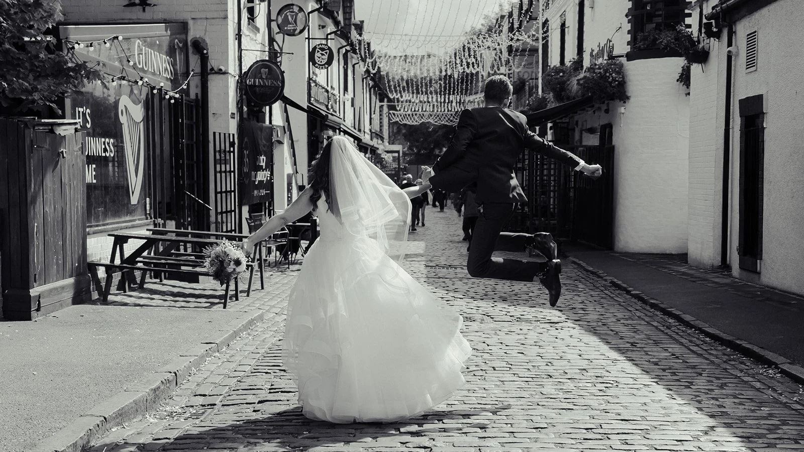 Happy Married Couple with groom in the air
