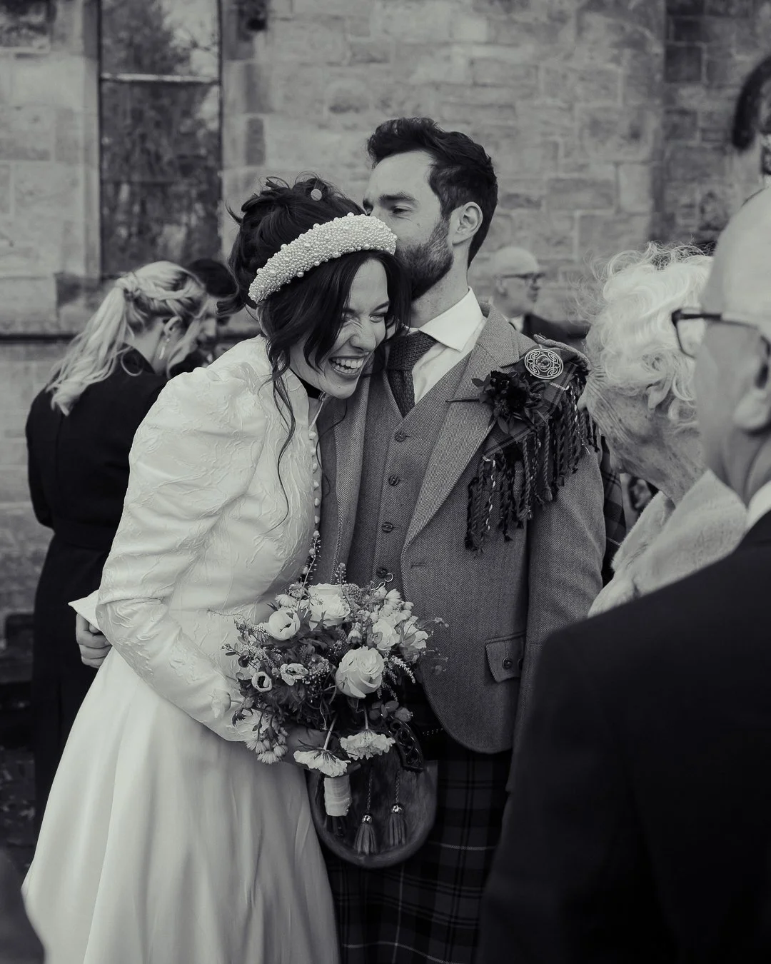 Happy bride and groom sharing a moment during their wedding ceremony, surrounded by family and friends.