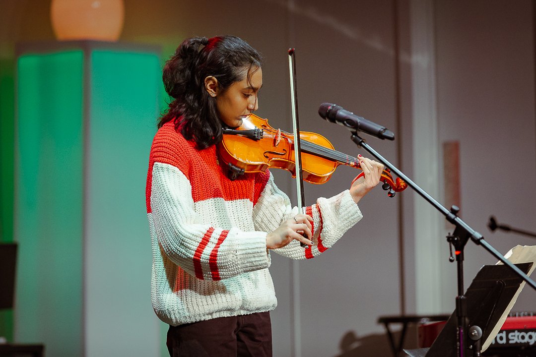 A student from Noteworthy Music Academy in West Bloomfield performing violin music on stage.