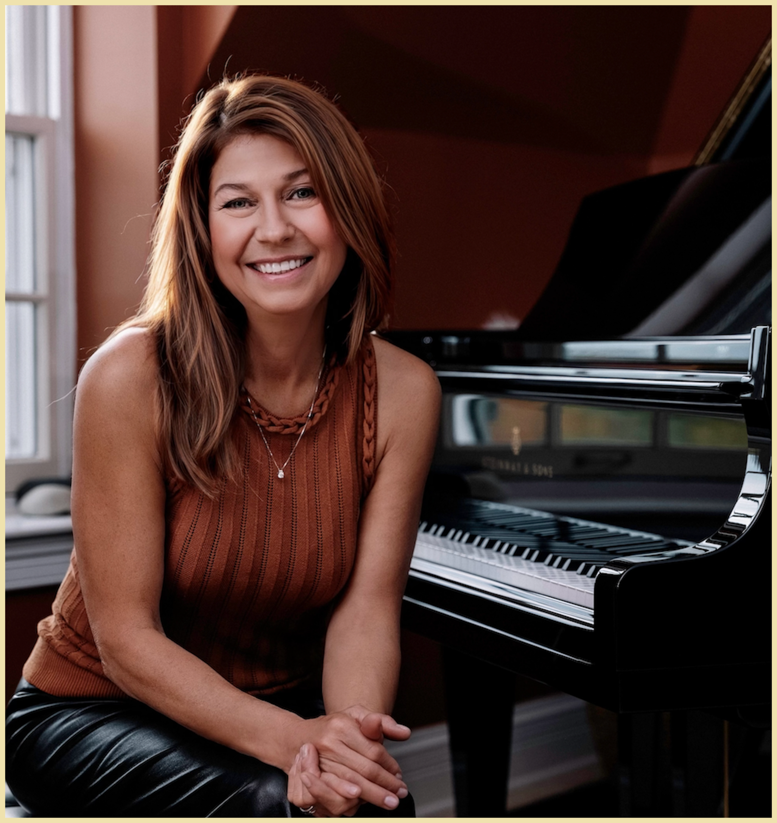 A woman with long brown hair, wearing an orange sleeveless top and black skirt, sitting beside a black Steinway grand piano in a room with a window and red walls, smiling at the camera.