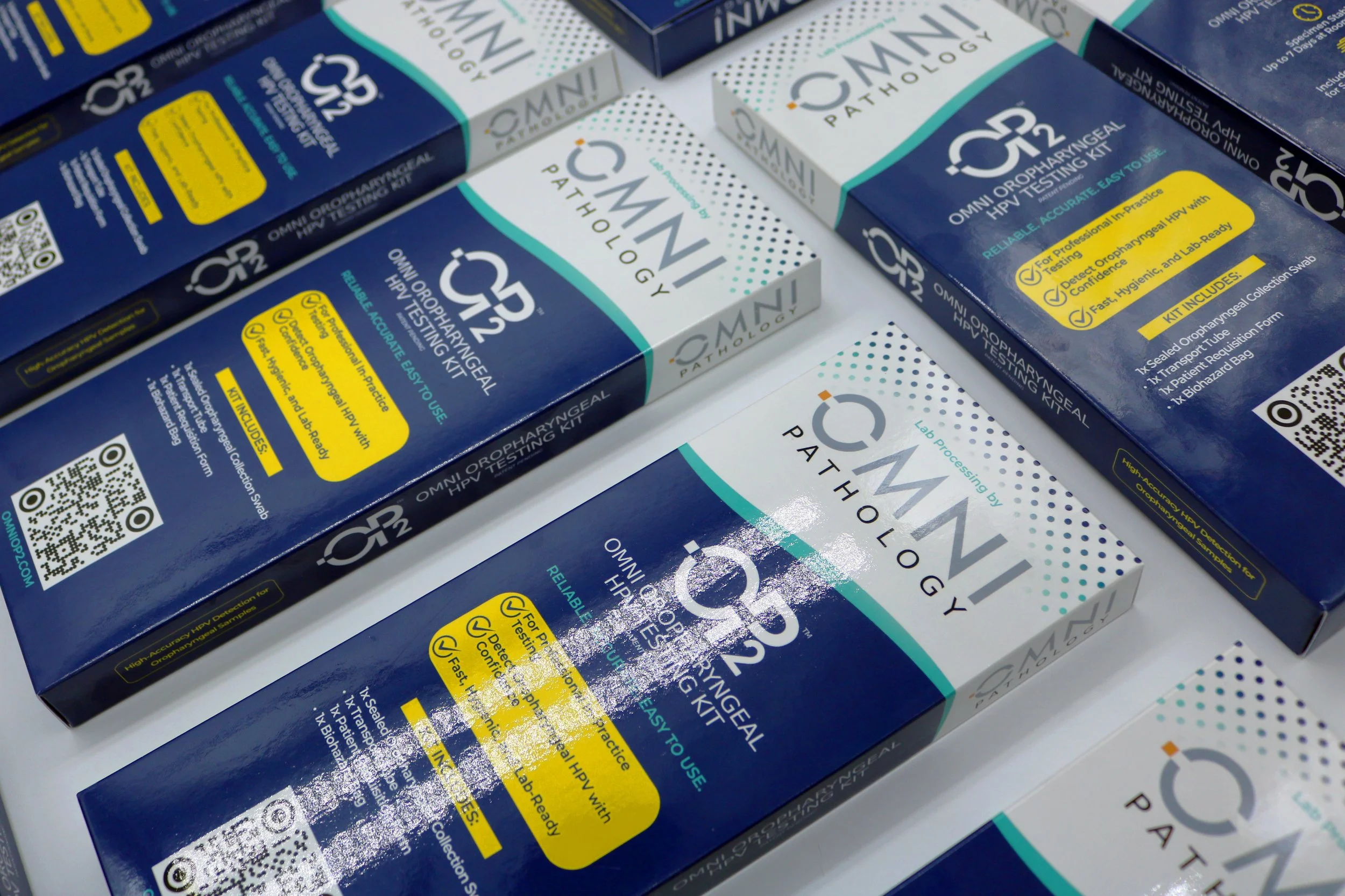 Boxes of OMNI OROPHARYNGEAL HPV TESTING KIT with labeling indicating reliability, ease of use, and lab readiness.
