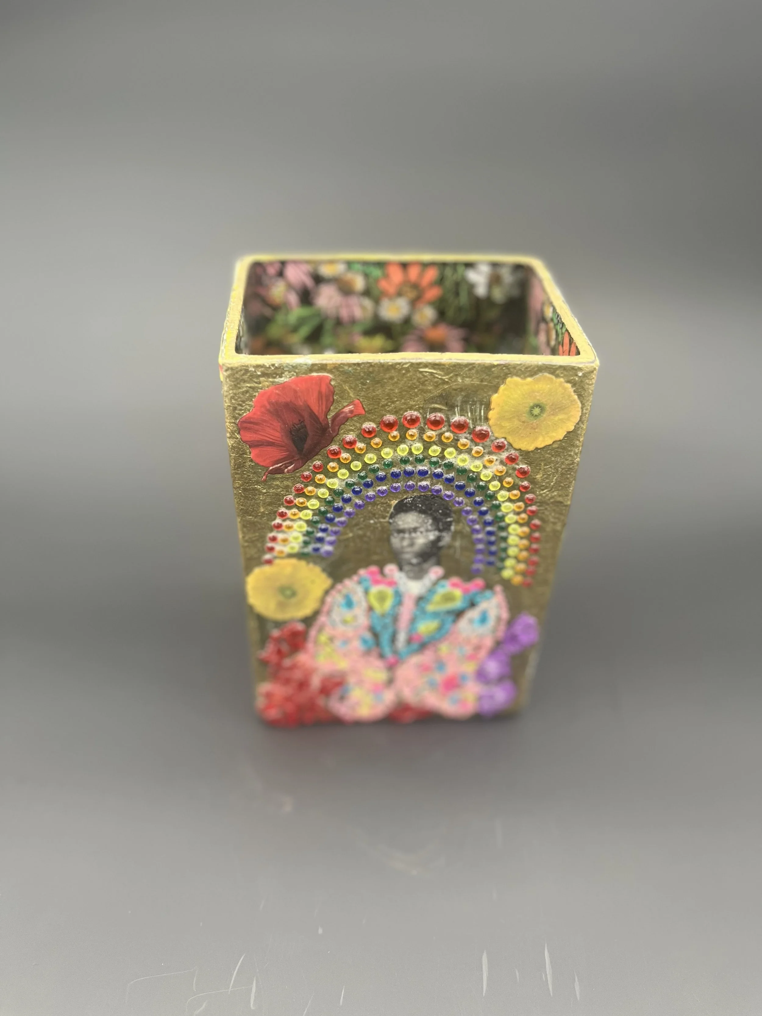 Title: The Bloom of Becoming
Vincent Dion Stringer
Mixed Media on Glass | 2024
Reverse decoupage, dotwork, archival images, rhinestones, gold leaf, varnish

The Bloom of Becoming is a one-of-a-kind glass vessel, hand-adorned with vibrant collage and 