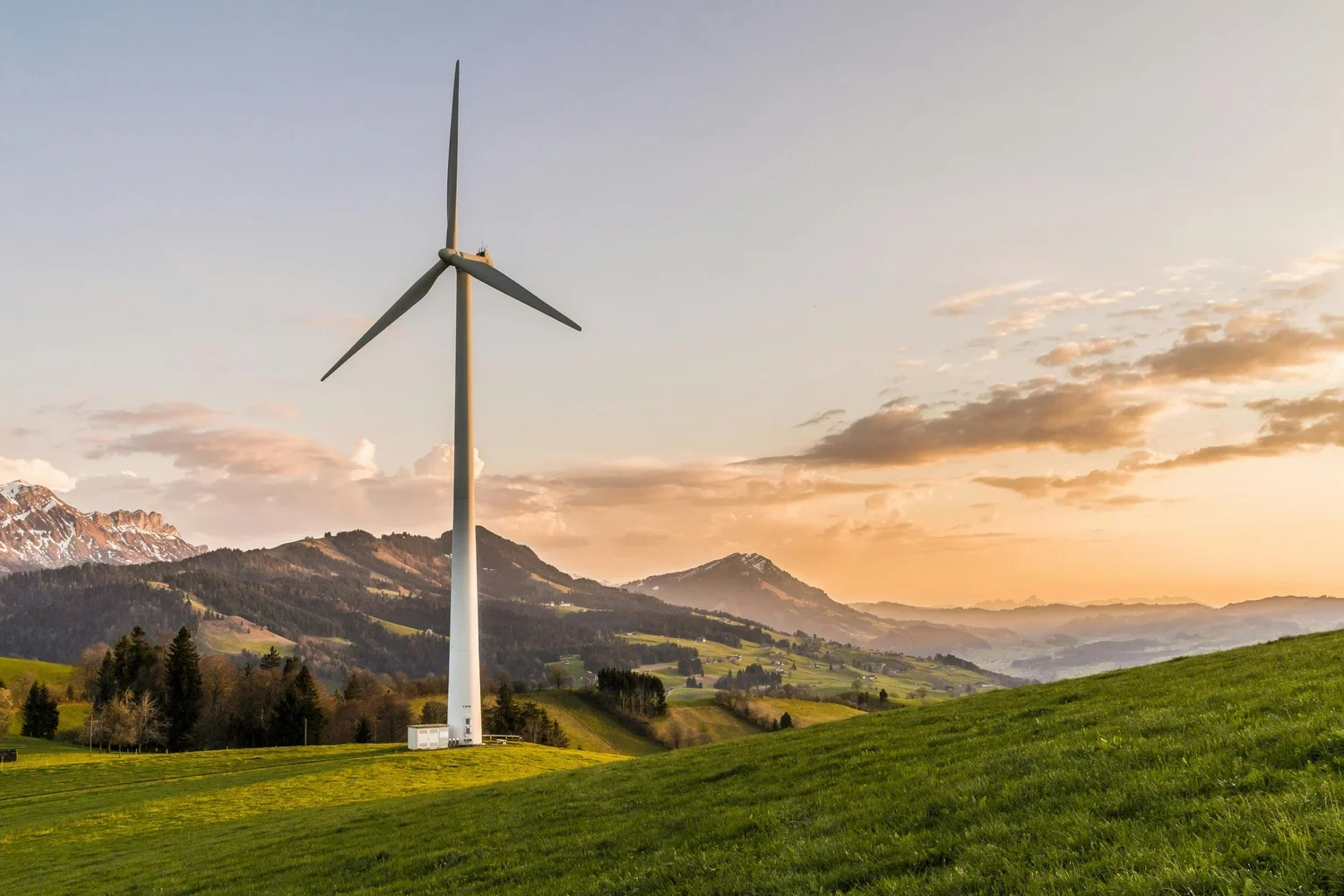 Wind turbine in a green mountain landscape.