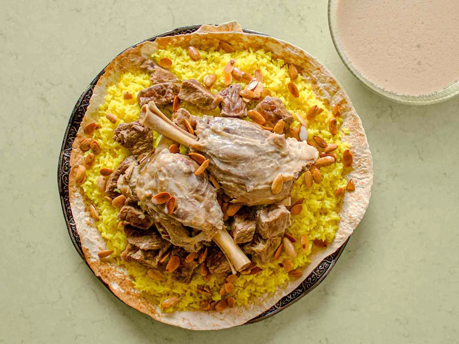 Mansaf – Lamb cooked in fermented yogurt sauce over rice, a festive favorite, linked to Hebron.