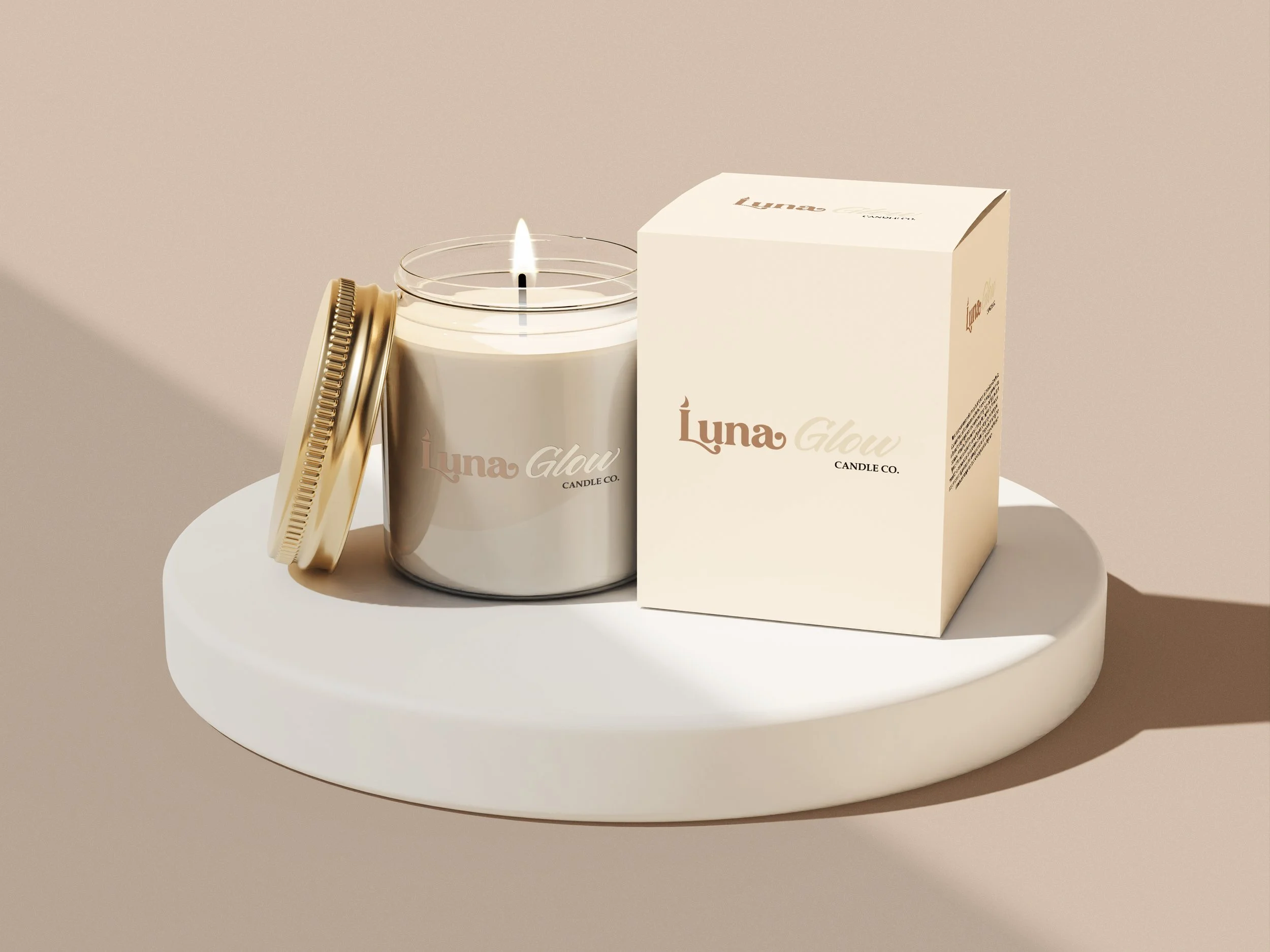A white candle with a flame is placed on a white round surface. Beside it is a white box with black text, and a closed gold-colored lid with a textured edge leaning against the candle.