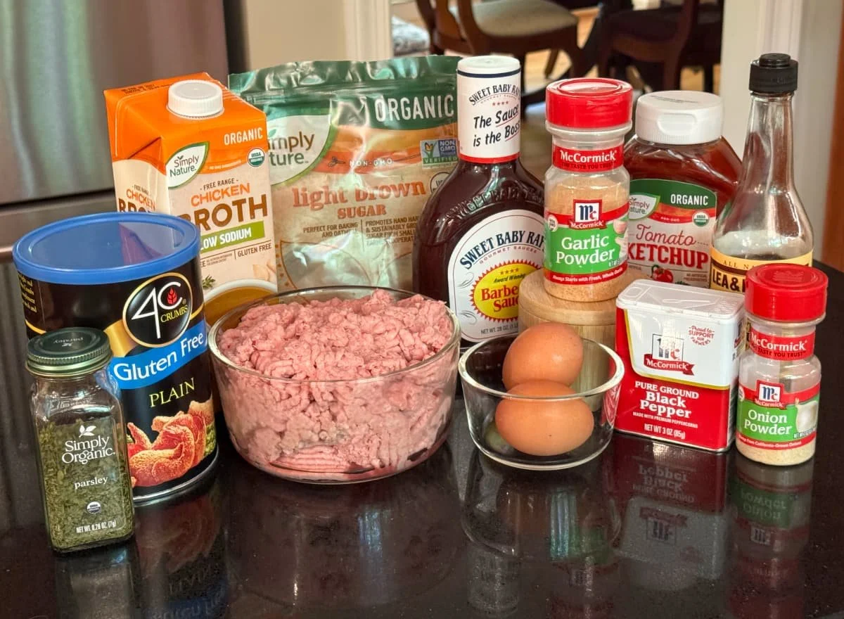 Ingredients for gluten-free dairy-free turkey meatloaf including ground turkey, gluten-free panko breadcrumbs, eggs, chicken broth, seasonings, ketchup, barbecue sauce, and Worcestershire sauce.