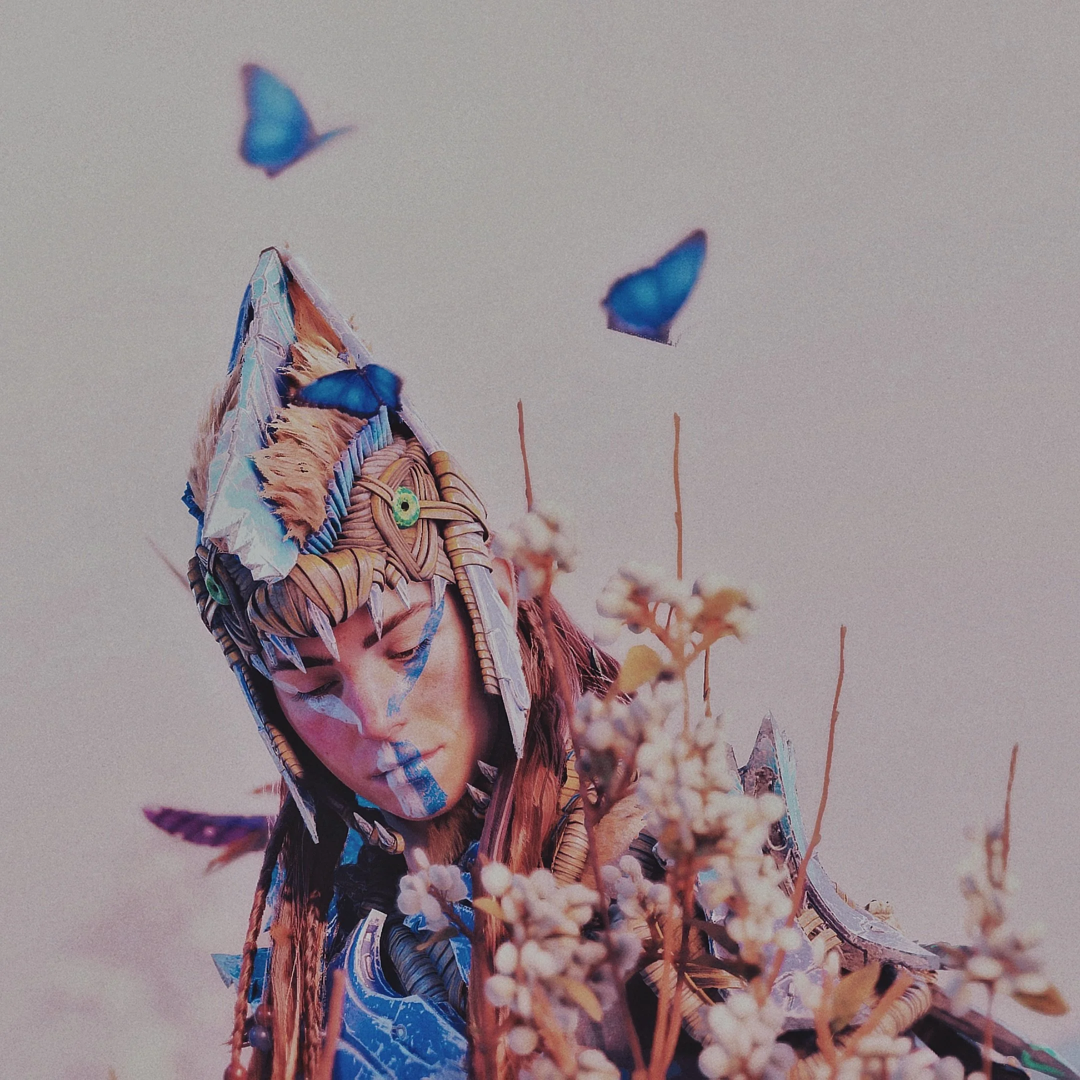 A person dressed in a colorful, elaborate costume with feathers, beads, and face paint, surrounded by small white flowers and blue butterflies. (Aloy)