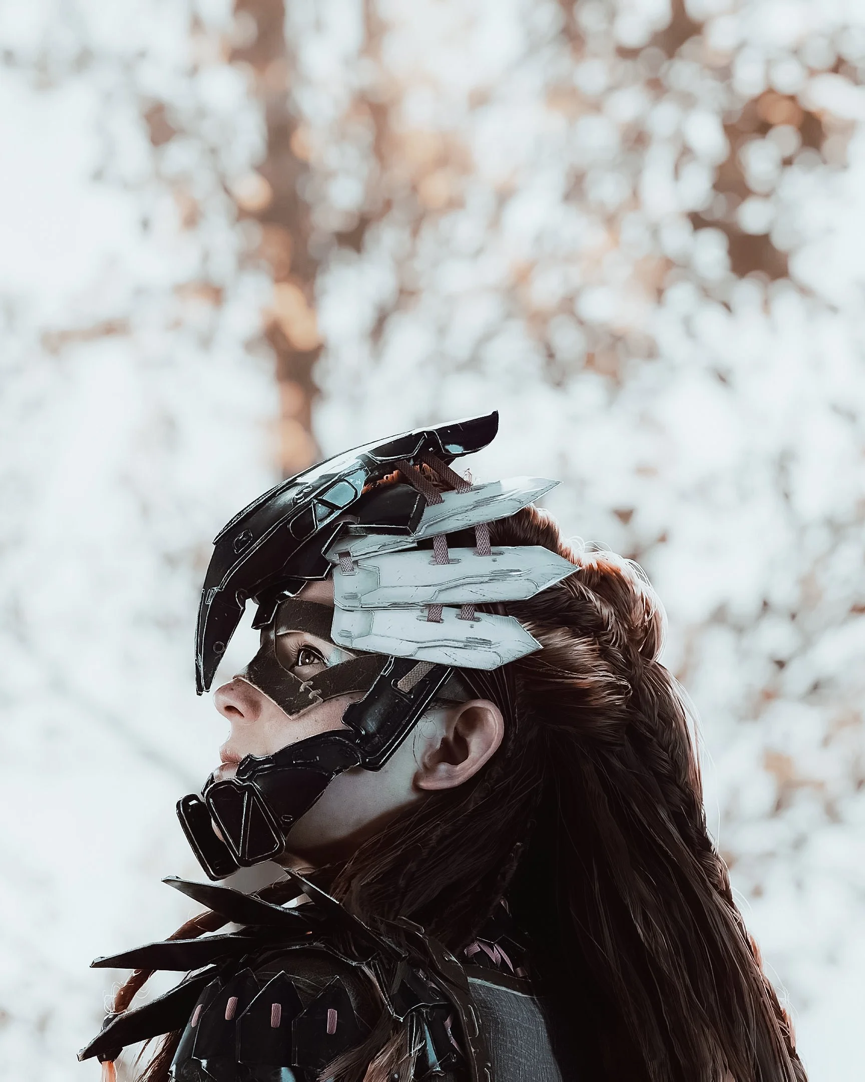 "I created this shot that reminds me of the softness of the season, fall. Muted colors, a gentle orange in the background, and the iconic Carja outfit to complete the look. The focus is on Aloy, looking ahead as the new season approaches." - Flawless