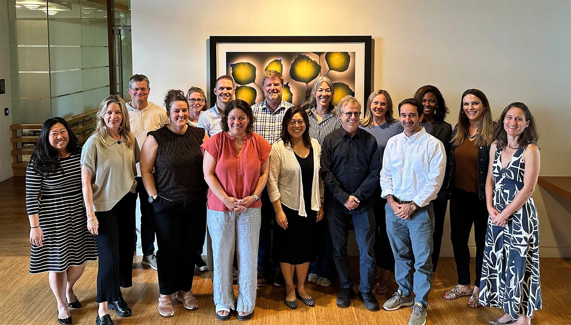Group photo of AIMS facilitation team members posing together during a collaborative session.